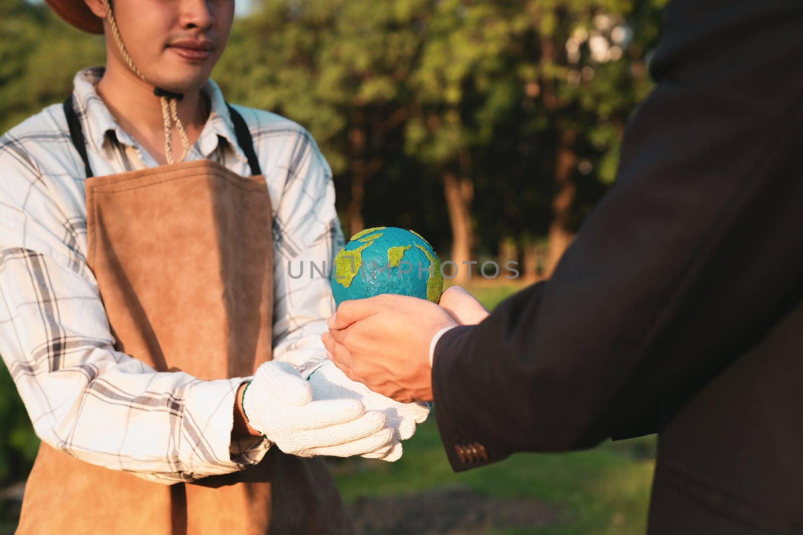 Eco-business company empower farmer with eco-friendly farming practice and clean agricultural technology. Cultivate sustainable future and holding Earth globe symbolize commitment to environment.Gyre