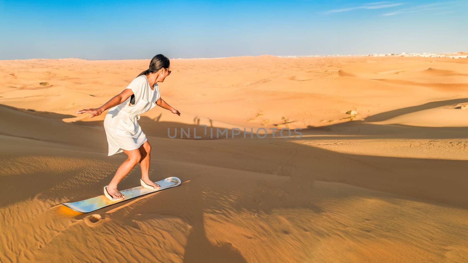 Dubai dessert sand dunes, couple on Dubai desert safari,United Arab Emirates, woman vacation in Dubai by fokkebok