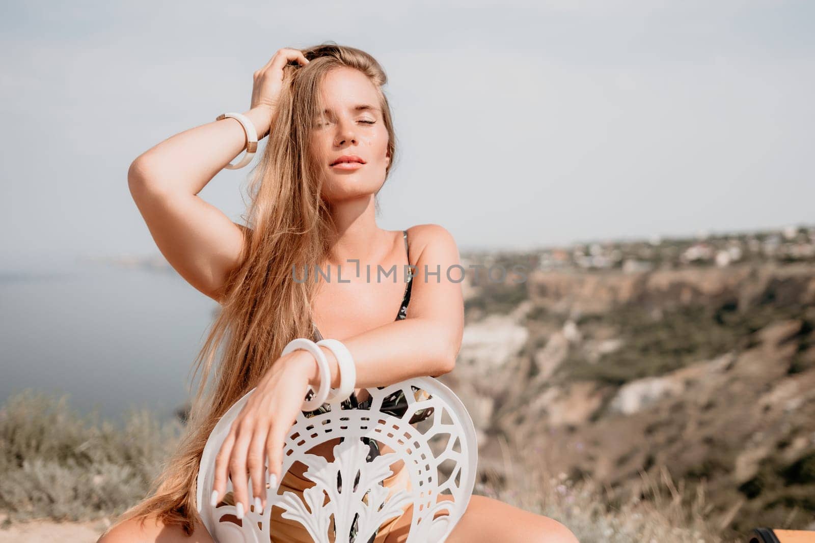 Happy boho woman portrait. Boho chic fashion style. Outdoor photo of free happy woman with long hair, sunny weather outdoors with sea mountains nature beautiful background. by panophotograph