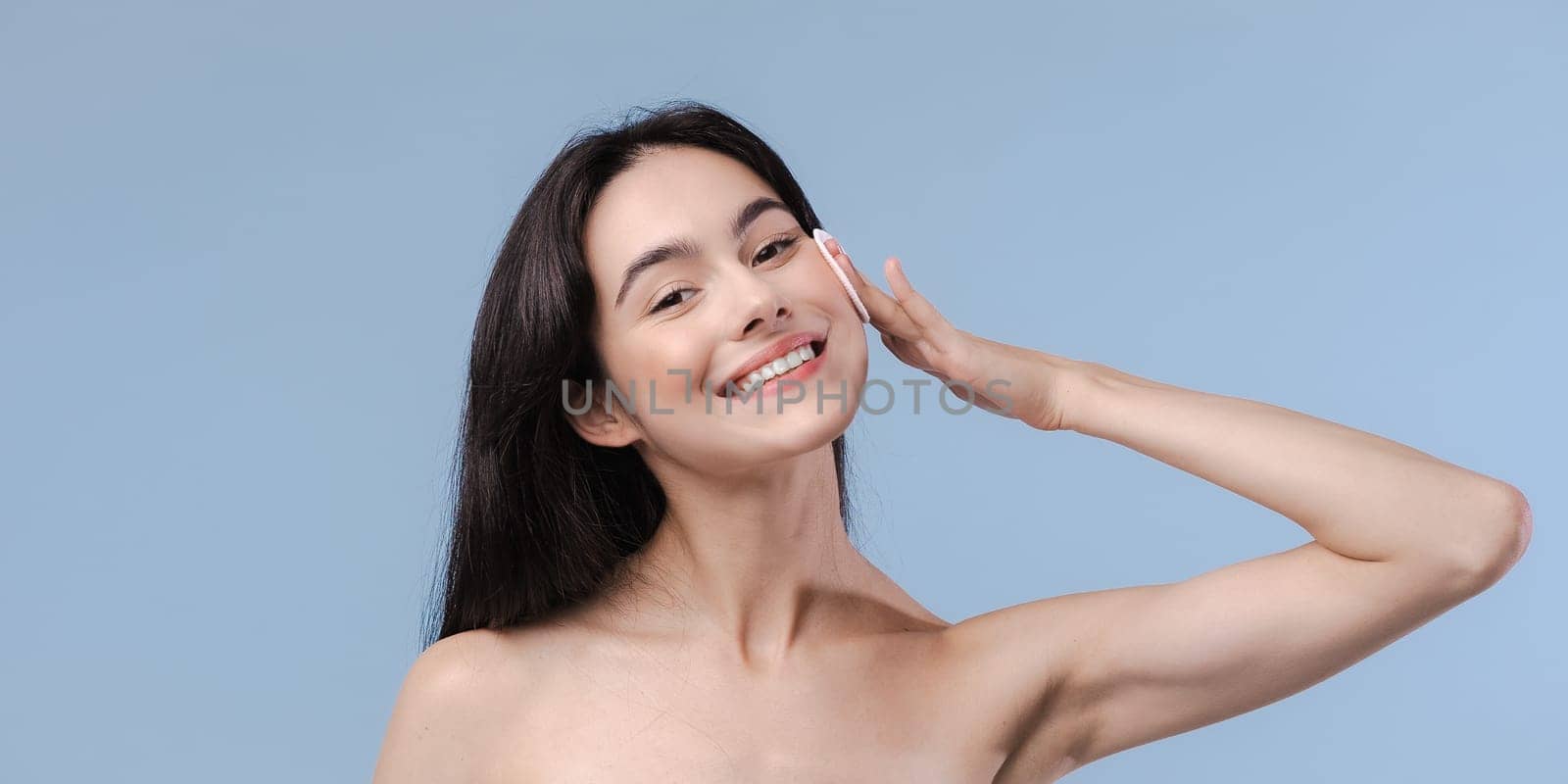 Skin cleaning. Young asian woman standing indoors. High quality photo