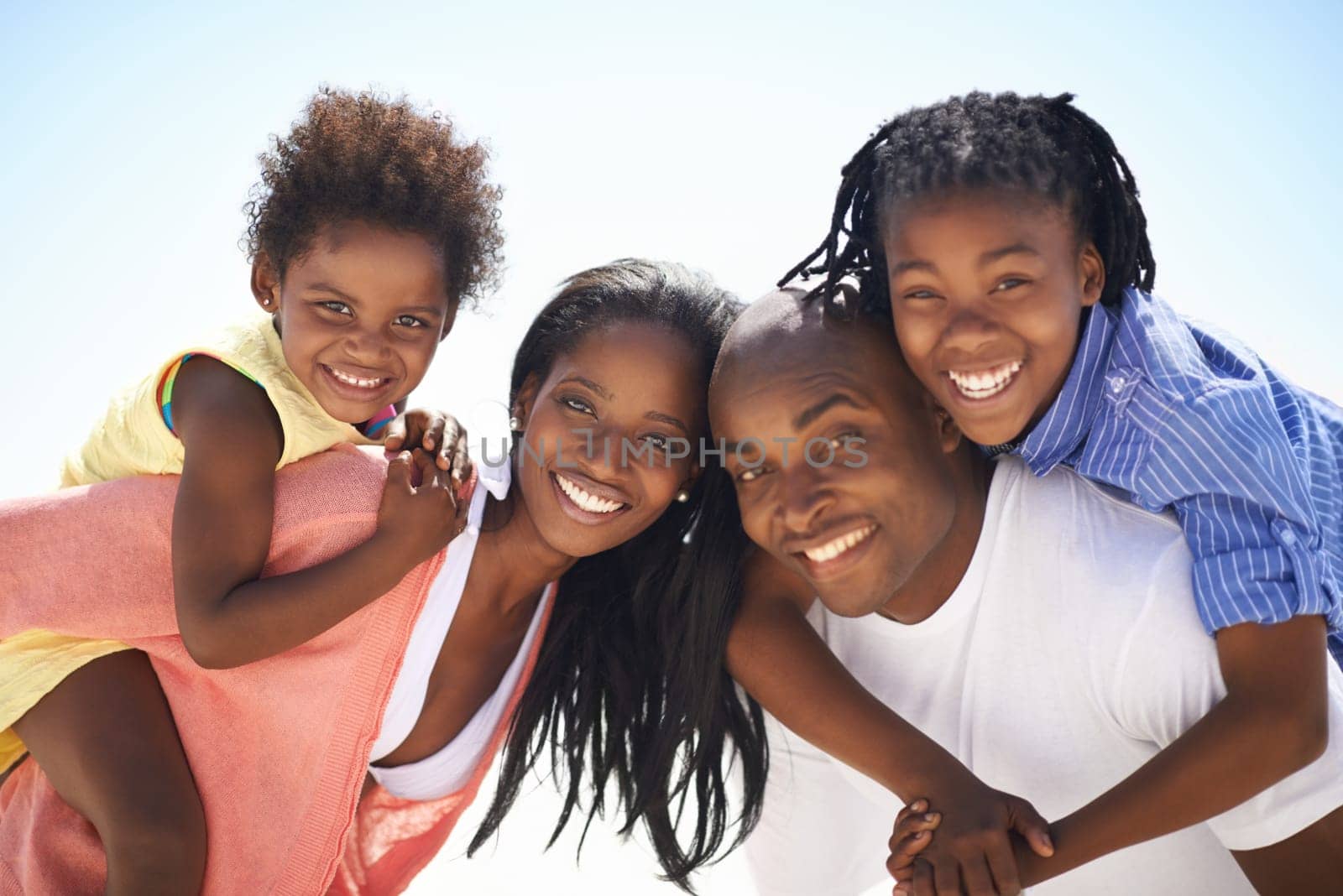 Black family, parents or children on piggyback at beach for adventure, holiday or vacation in summer. African people, face or smile outdoor in nature for break, experience or bonding and relationship by YuriArcurs