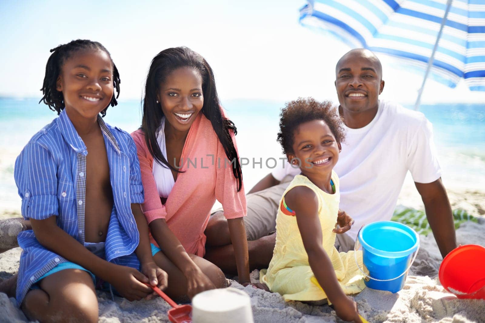 African family, parents or children and portrait at beach for adventure, holiday or vacation in summer. Black people, face or smile outdoor in nature for playing, experience or bond and relationship by YuriArcurs