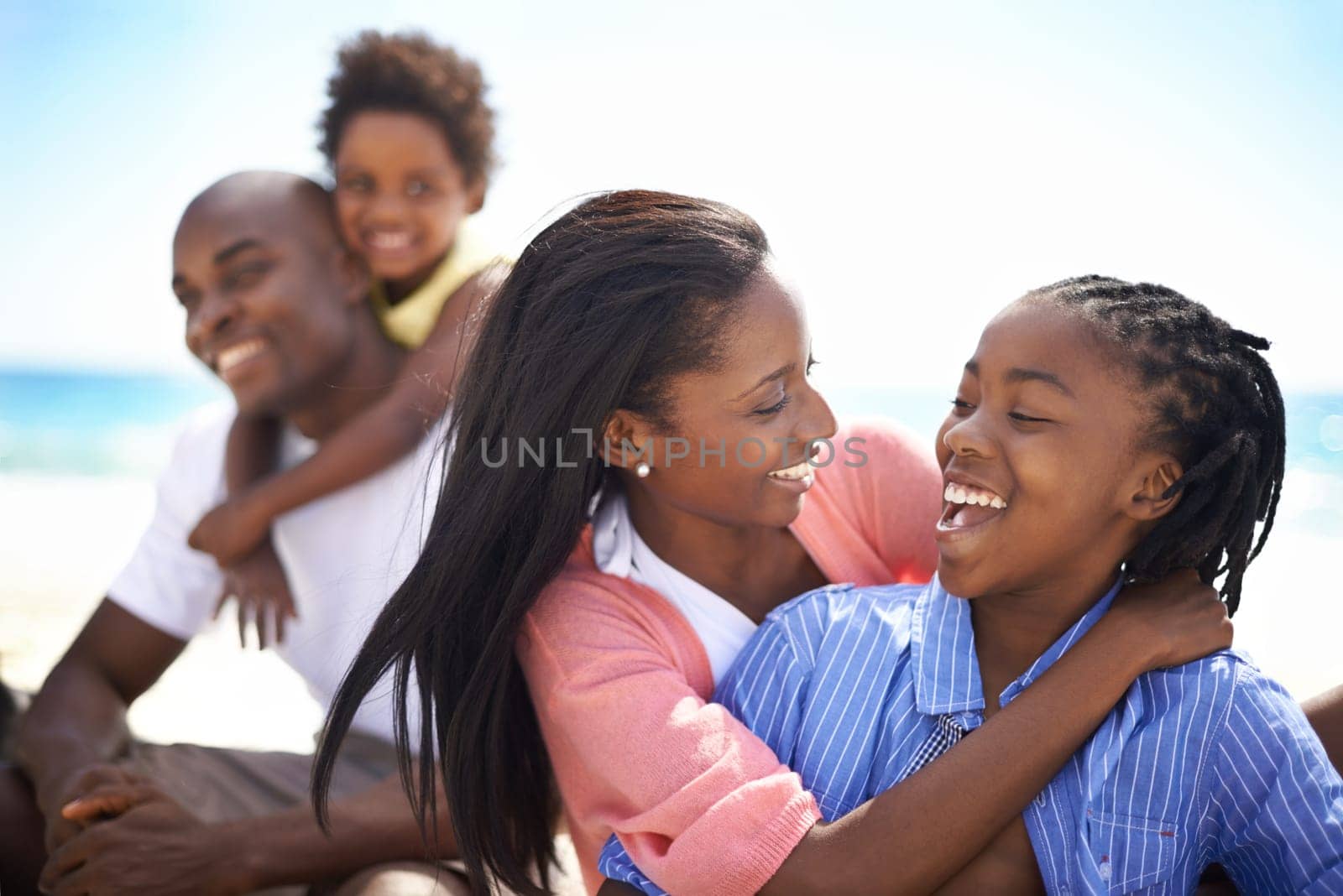 Black family, parents or children and laughing at beach for adventure, holiday or vacation in summer. African people, face or smile outdoor in nature for break, experience or bonding and relationship by YuriArcurs