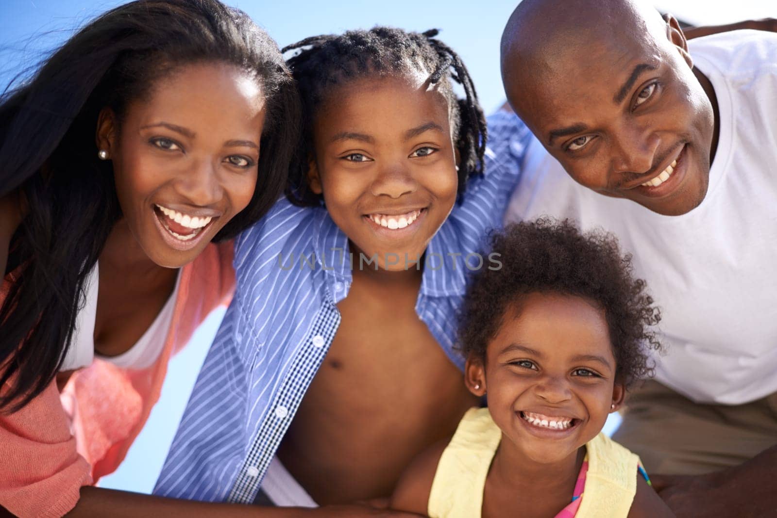 African family, parents or children and portrait at beach for adventure, holiday or vacation in summer. Black people, face or smile outdoor in nature for break, experience or bonding and relationship.