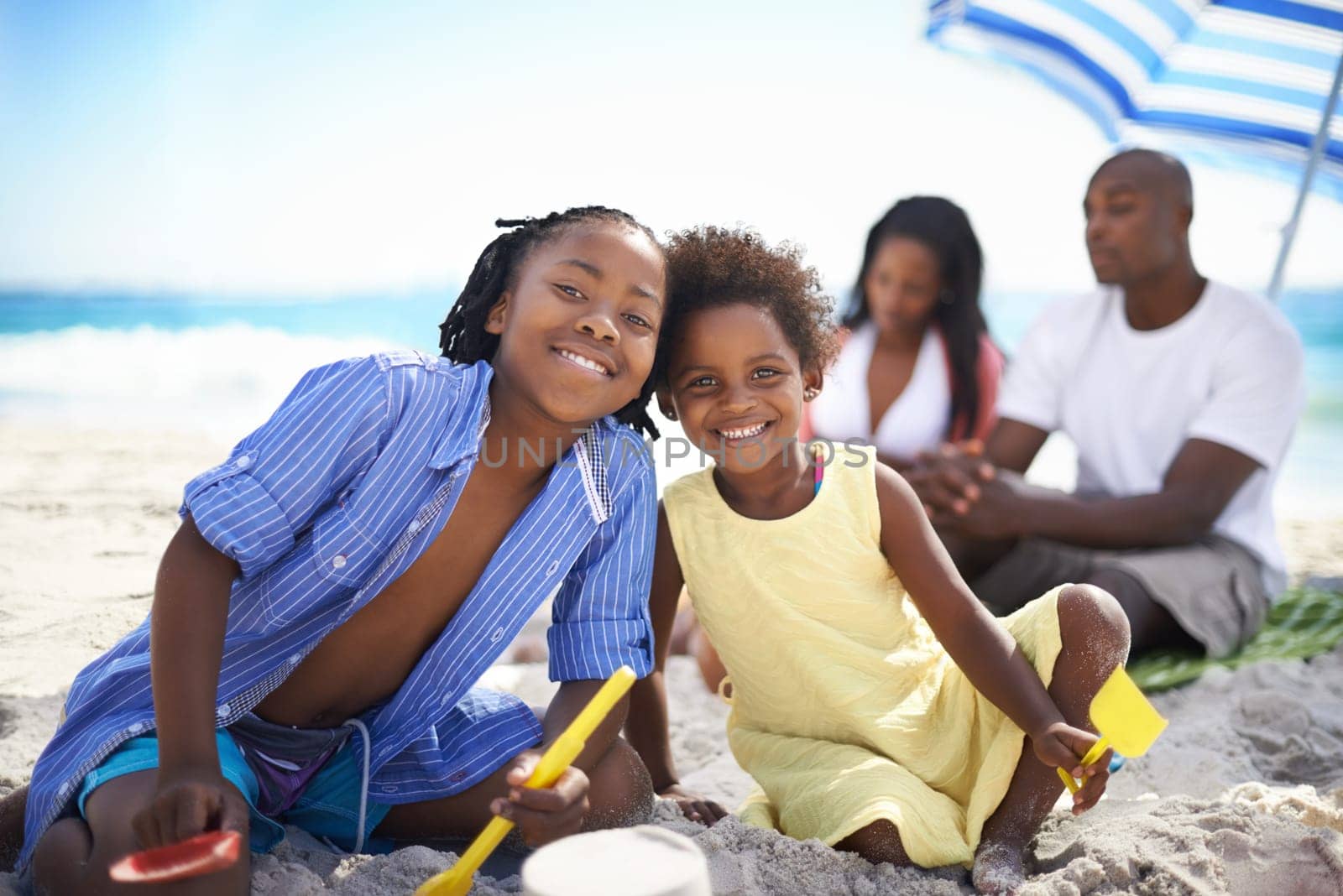 Black family, parents or children and portrait at beach for adventure, holiday or vacation in summer. African people, face or smile outdoor in nature for break, experience or bonding and relationship by YuriArcurs