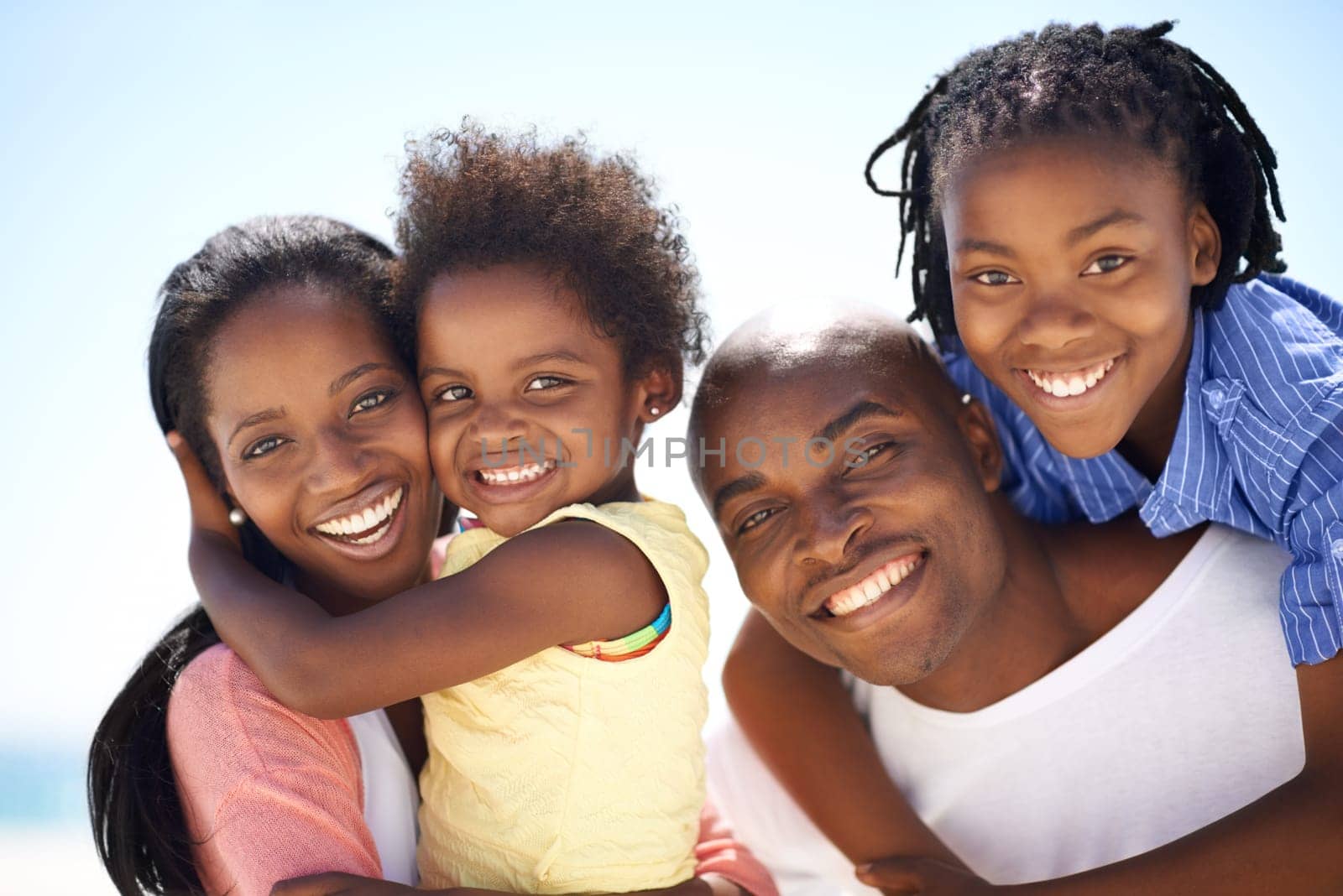 African family, parents and kids with portrait on beach for adventure, holiday or vacation in summer. Black people, face and smile outdoor in nature for break, piggyback or bonding with relationship by YuriArcurs