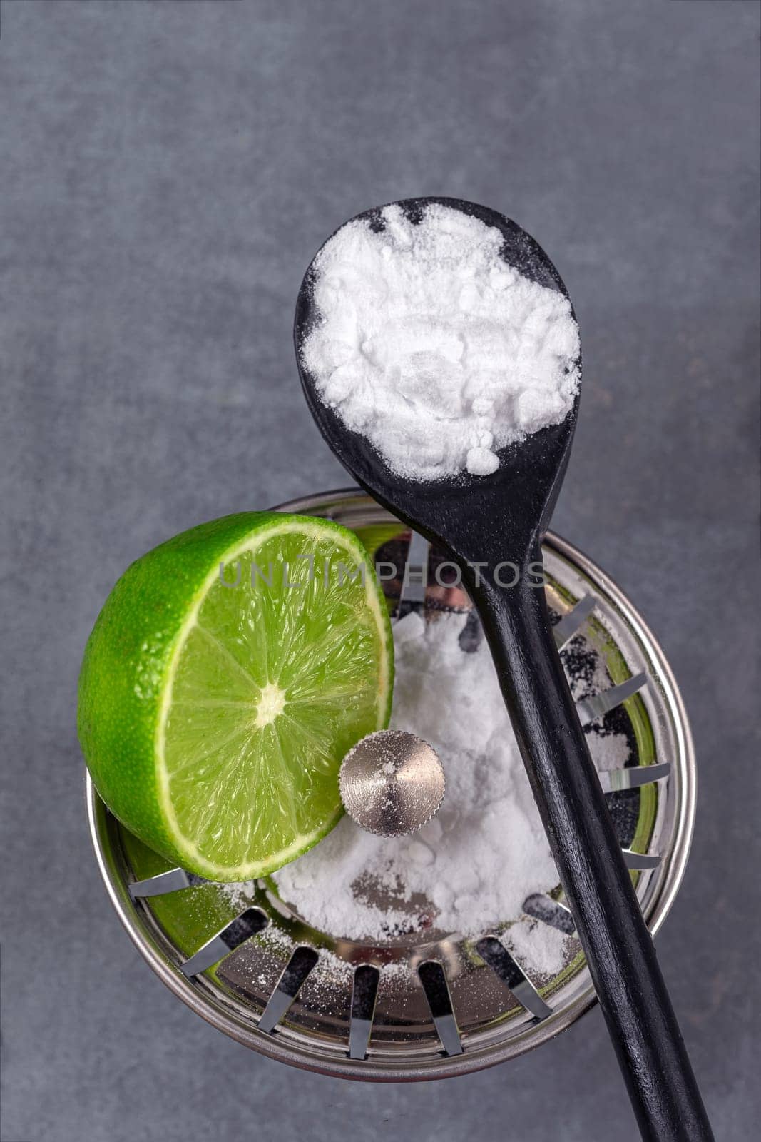 baking soda on drain in kitchen sink from glass jar. Close up. Eco friendly house cleaning concept. by JPC-PROD