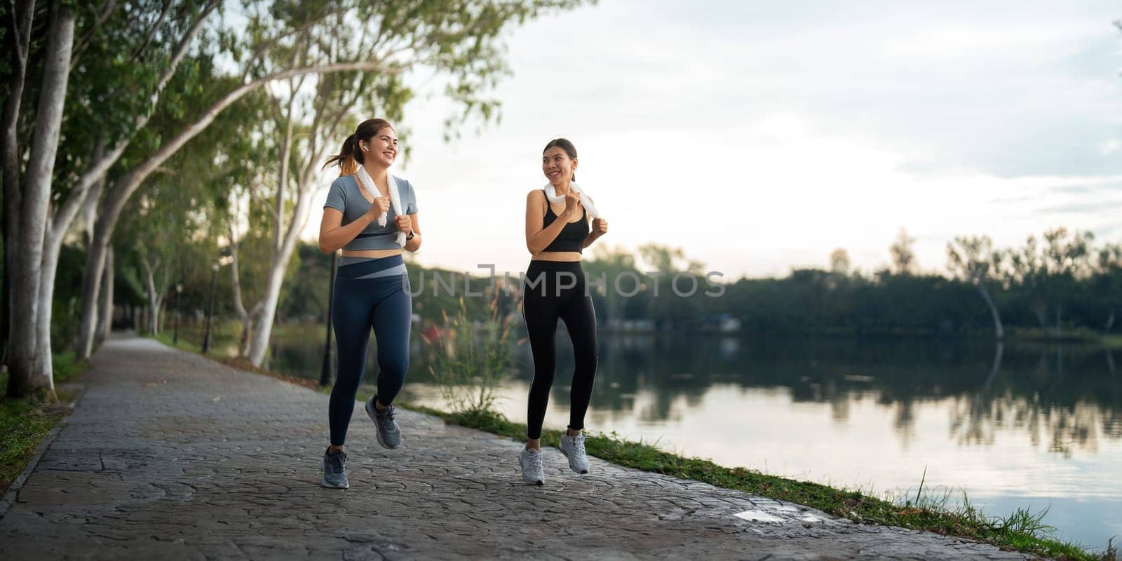 Healthy and active lifestyle, sport concept. Attractive ecstatic young sportswoman, smiling joyfully as jogging, sprinter run in park by nateemee