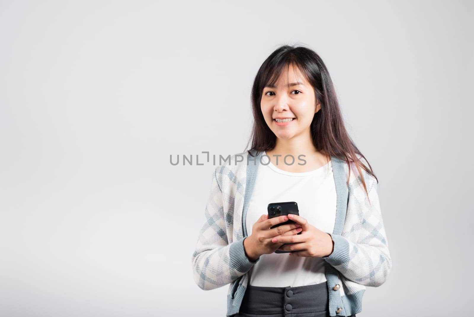 Woman excited read social network feedback on smartphone by Sorapop