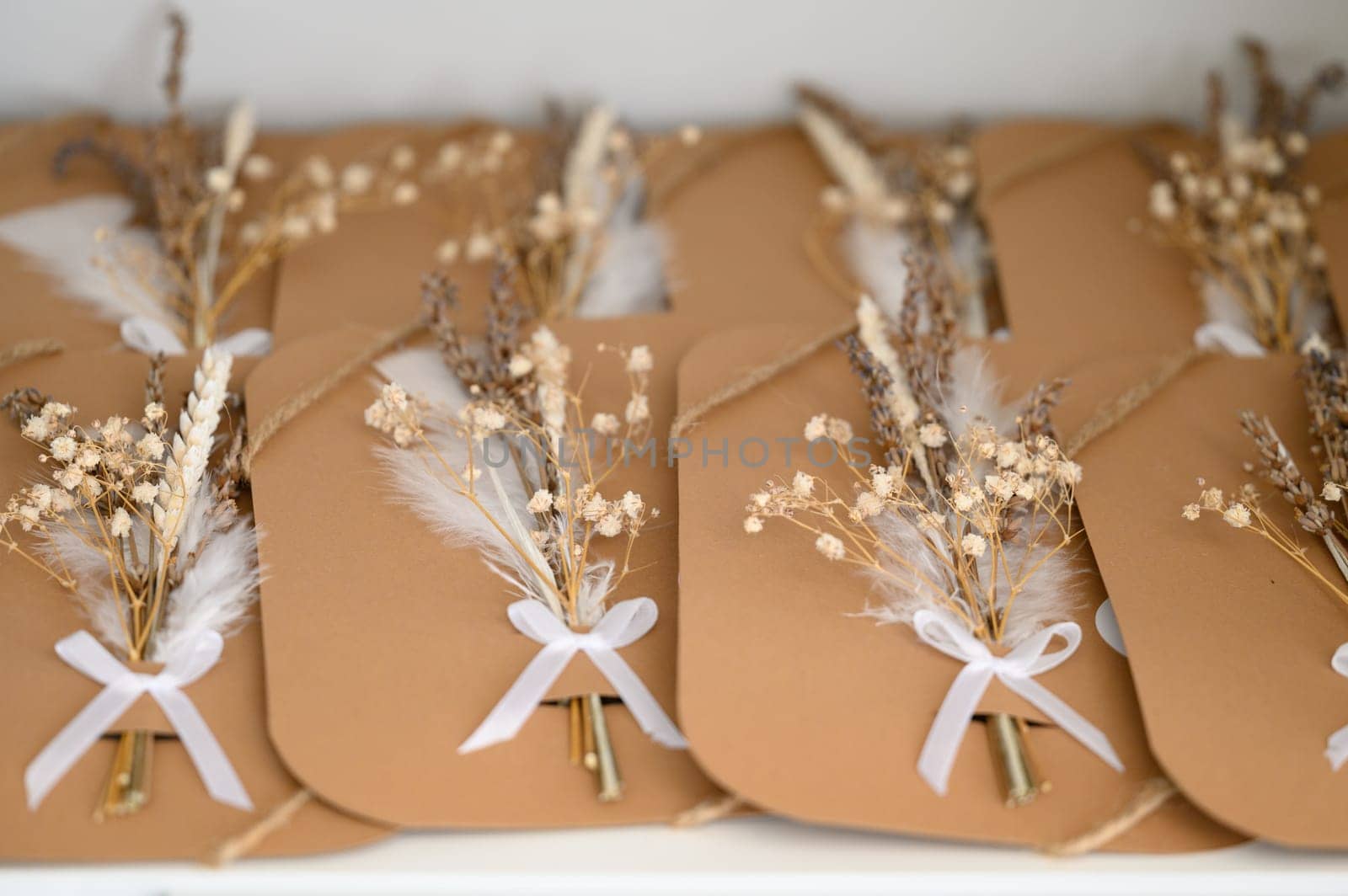 Gift cards with ikibana of dried flowers, brown paper cards.