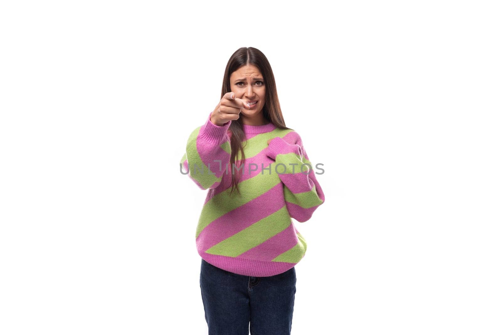 young active caucasian woman with black hair dressed in a pink striped jacket on a white background.
