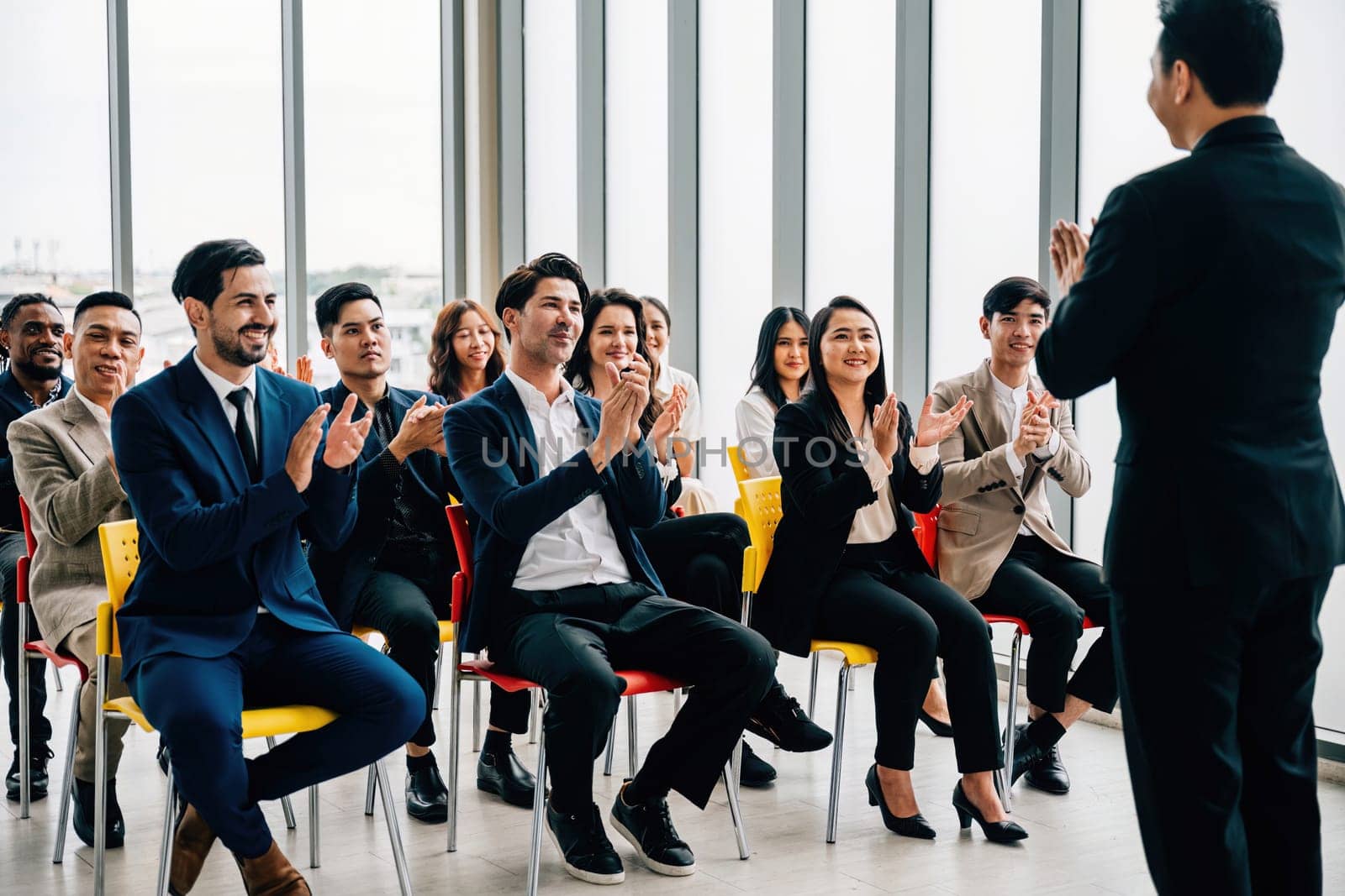 Commendable achievement Diverse business team claps hands, acknowledging the success of a new product in a vibrant office setting. Collaborative spirit, motivation, and teamwork shine through