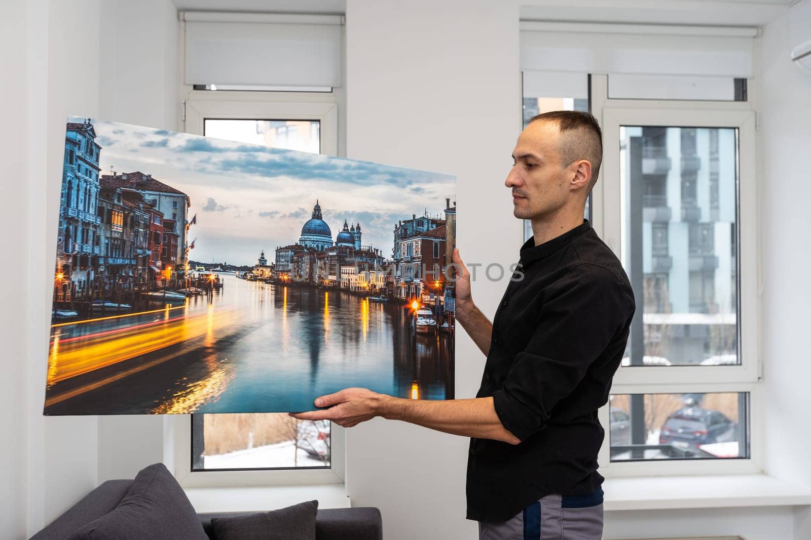 Photo canvas print. A man holding a photography with gallery wrap. High quality photo