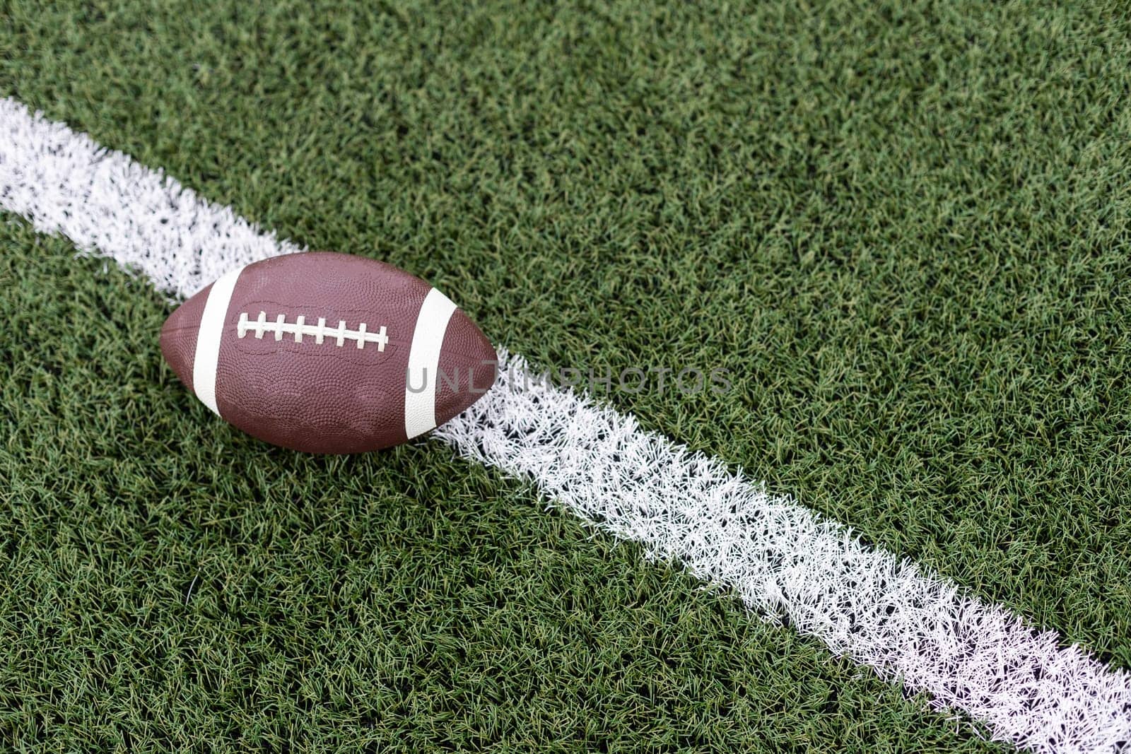 American football on football field background. High quality photo