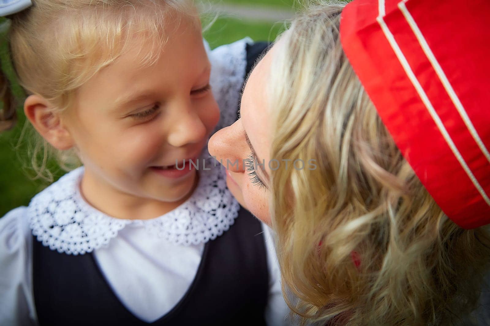 Young and adult schoolgirl on September 1. Generations of schoolchildren of USSR and modern Russia. Female pioneer in red tie and October girl in modern uniform. Daughter and Mother having fun