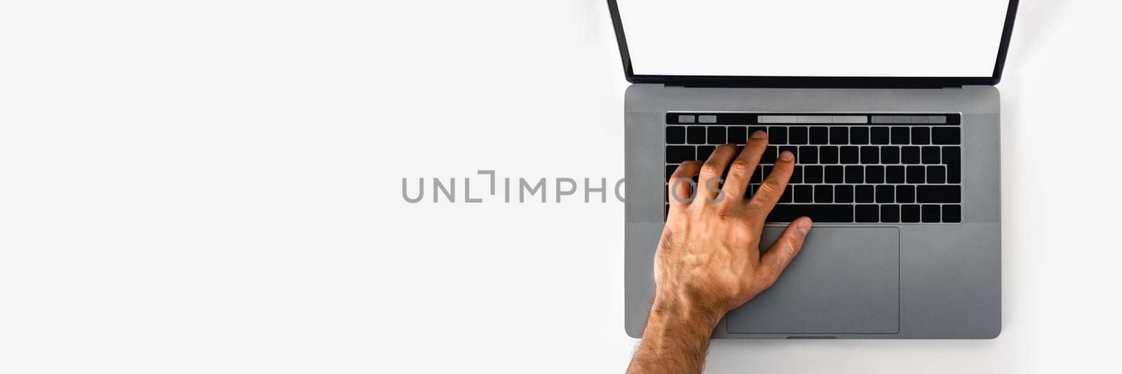 Web banner with man hand working at laptop on white table.
