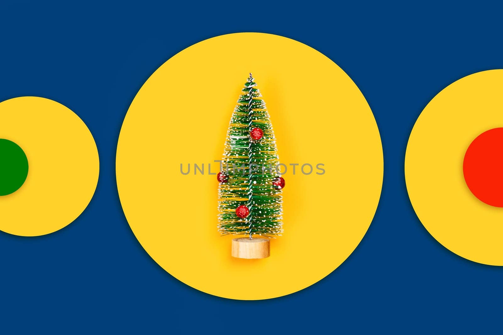 Christmas and New year yellow decorative background with one christmas tree. Flat lay, top view, copy space.