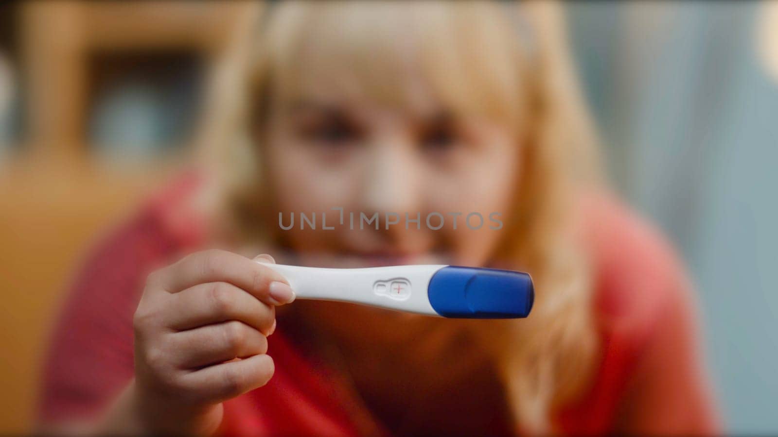 close up of woman holding pregnancy test. Young woman holding pregnancy test, shallow depth of field. Pregnancy Test showing a negative result.