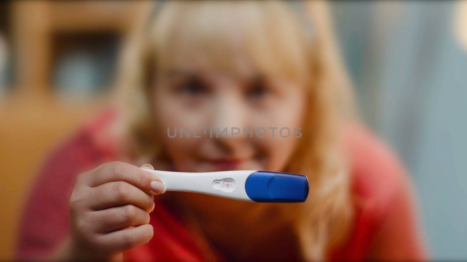 close up of woman holding pregnancy test. Young woman holding pregnancy test, shallow depth of field. Pregnancy Test showing a negative result by Mediawhalestock