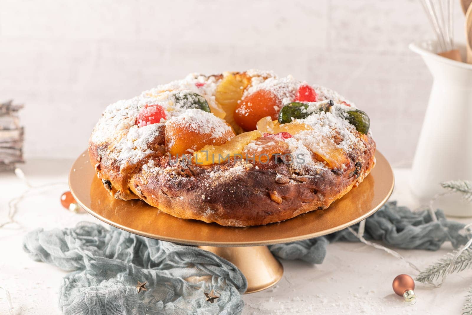 Bolo do Rei or King's Cake, Made for Christmas, Carnavale or Mardi Gras with Christmas season elements in Background.