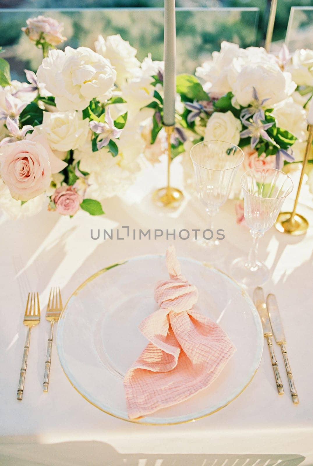 Knotted napkin lies on a plate on a set table. High quality photo