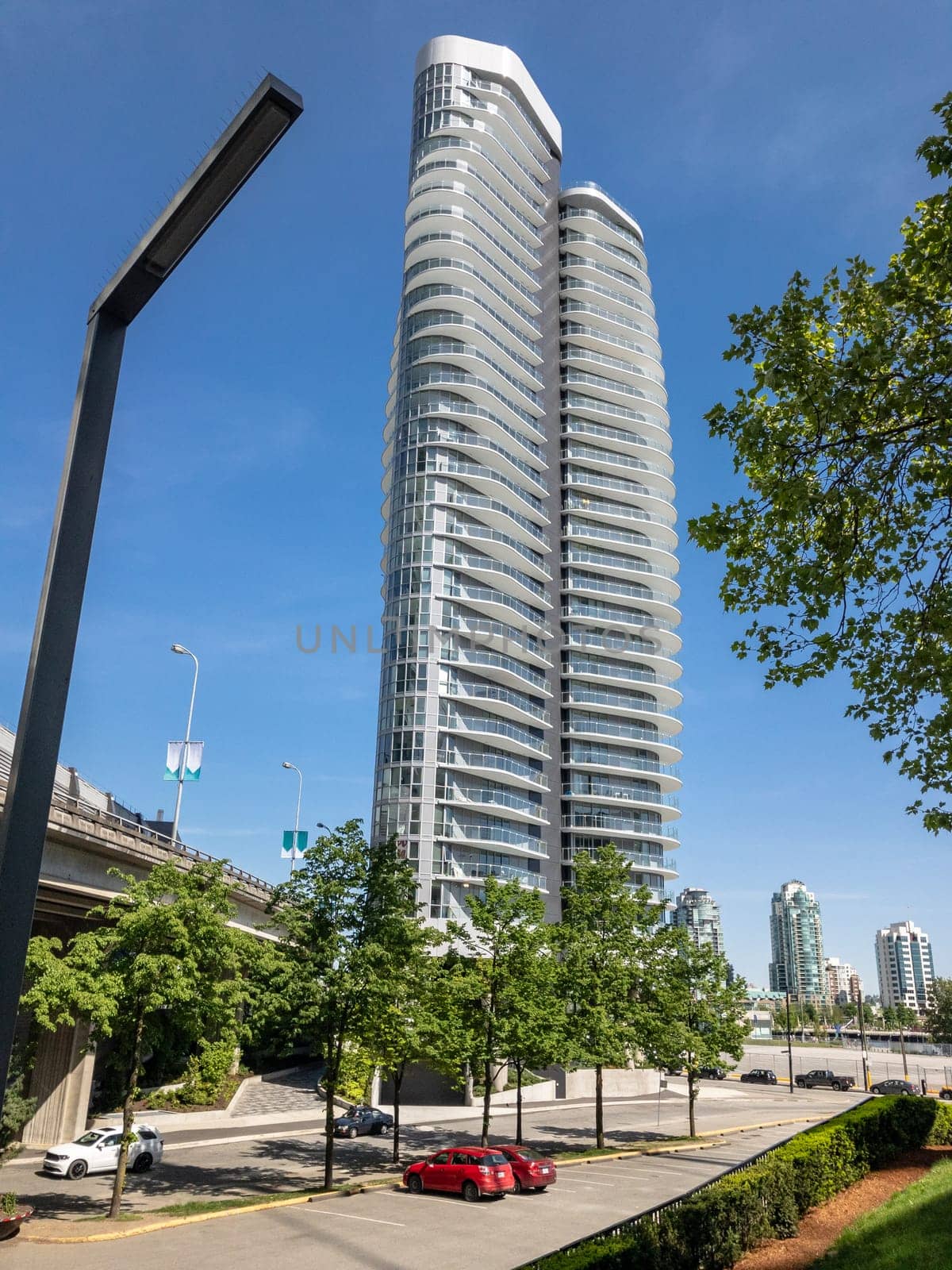 Urban area around high-rise residential tower on blue sky background