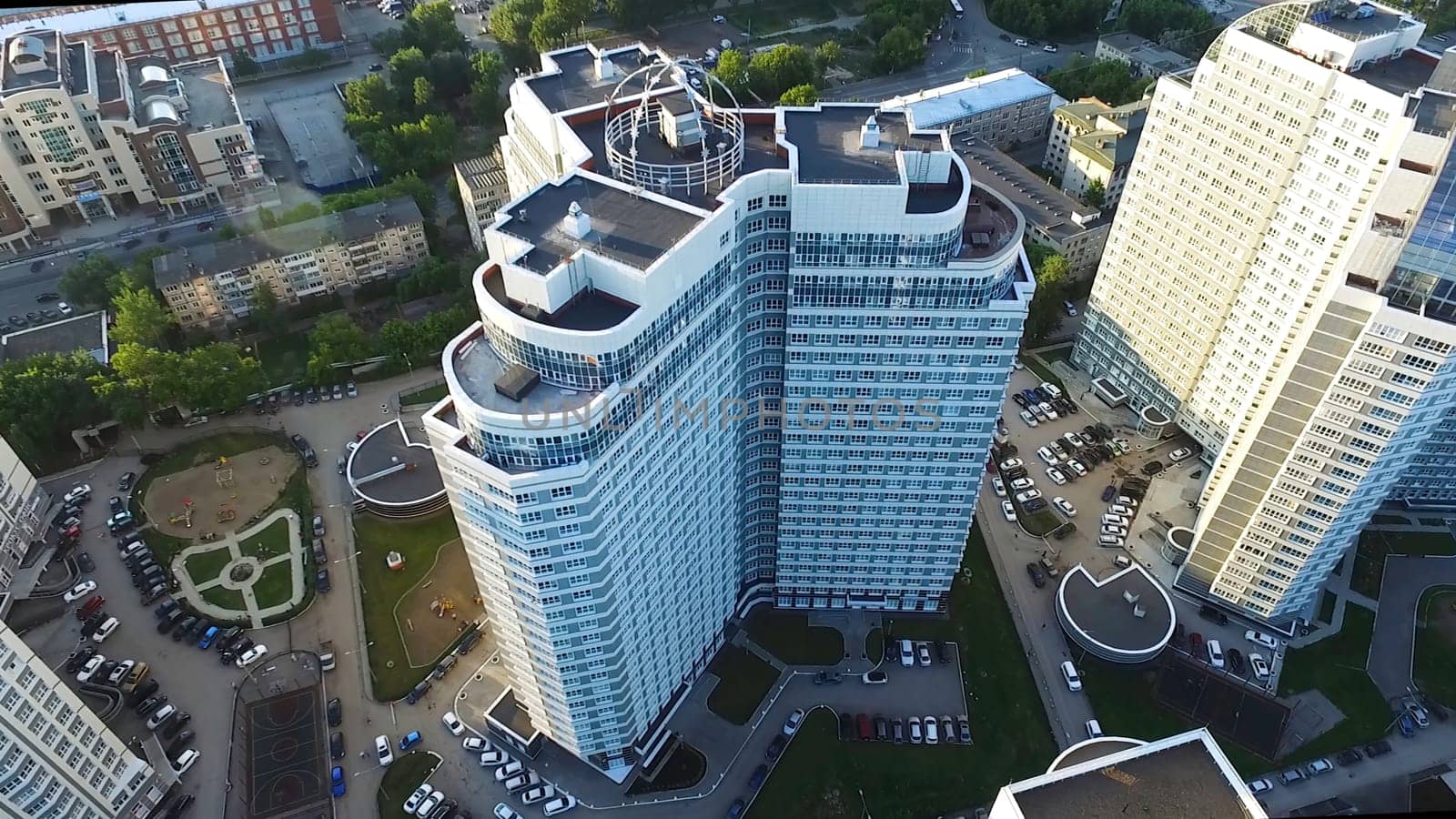 Top view of a modern residential complex with high beautiful houses. Clip. A large window in an apartment building. Many windows on brick building.