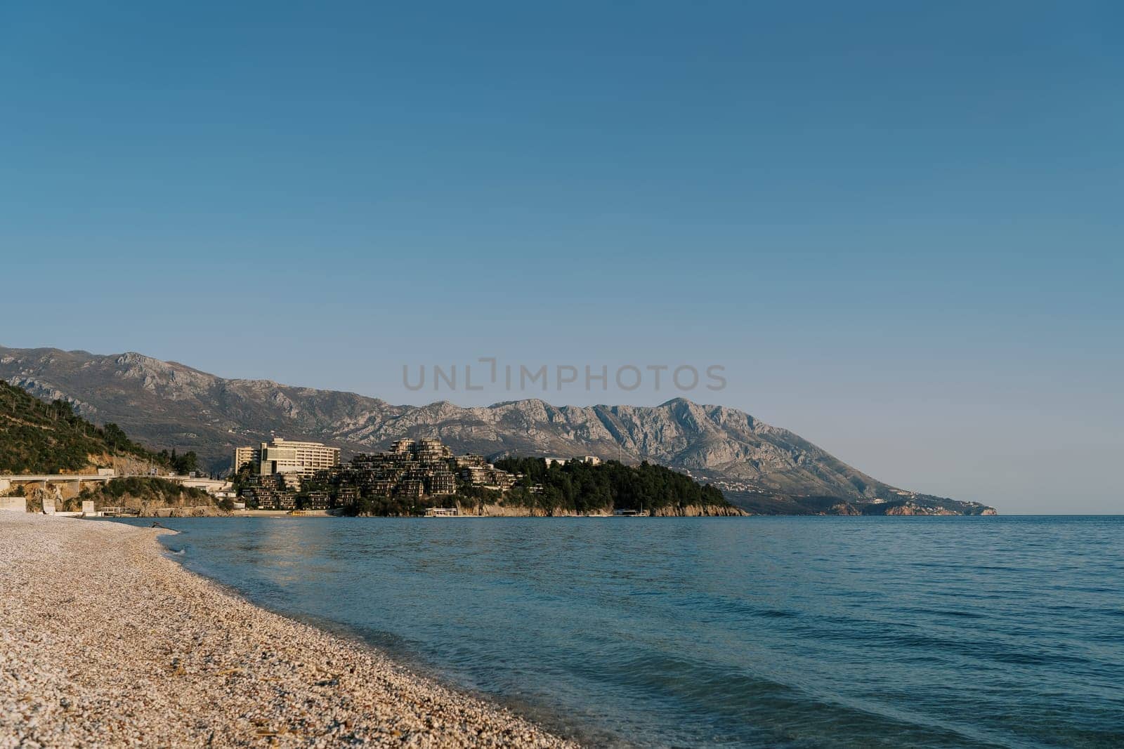 Deserted main beach of Budva overlooking the mountains by the sea. Montenegro. High quality photo