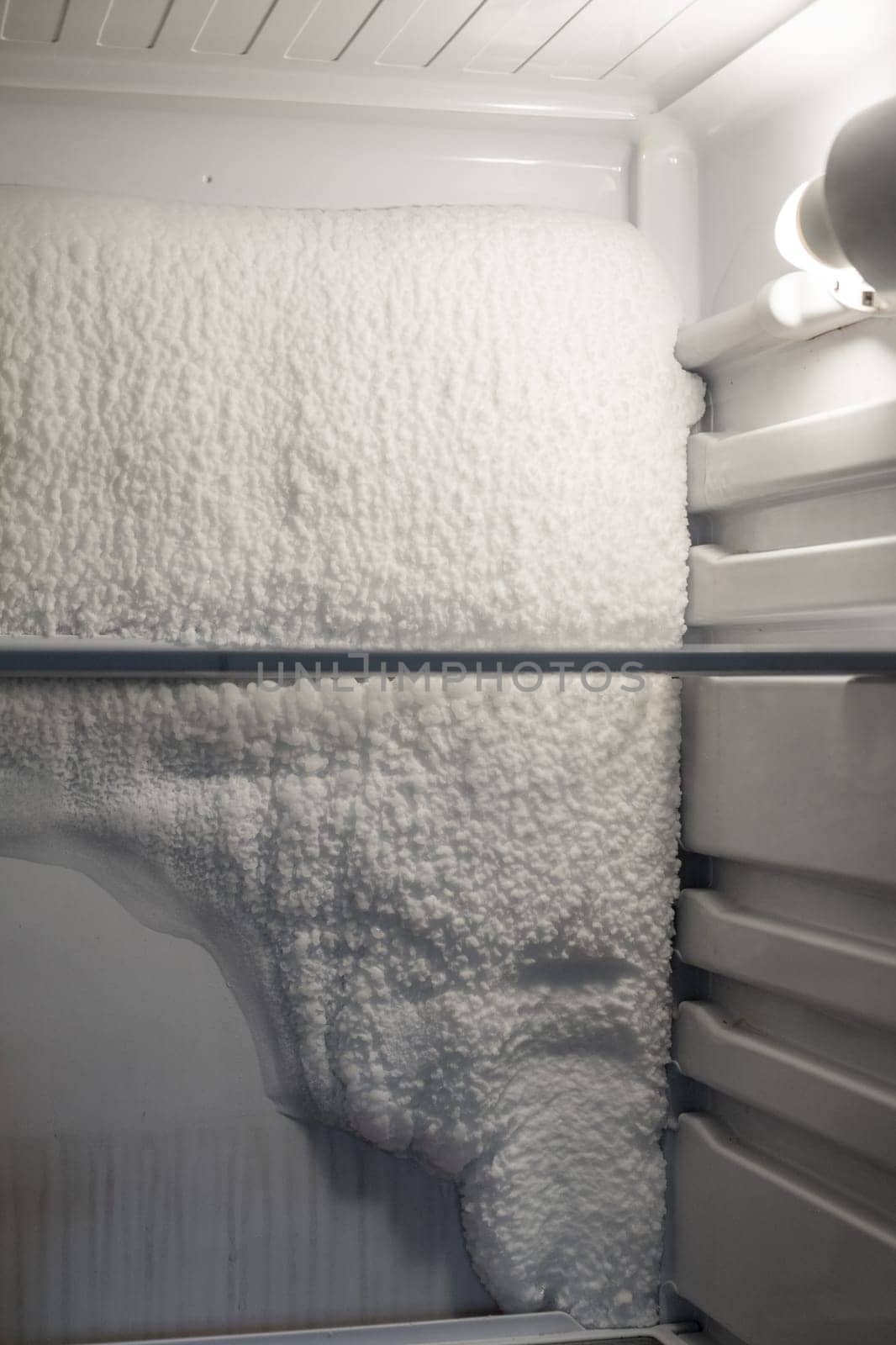 Frozen refrigerator that needs to be defrosted. by AnatoliiFoto