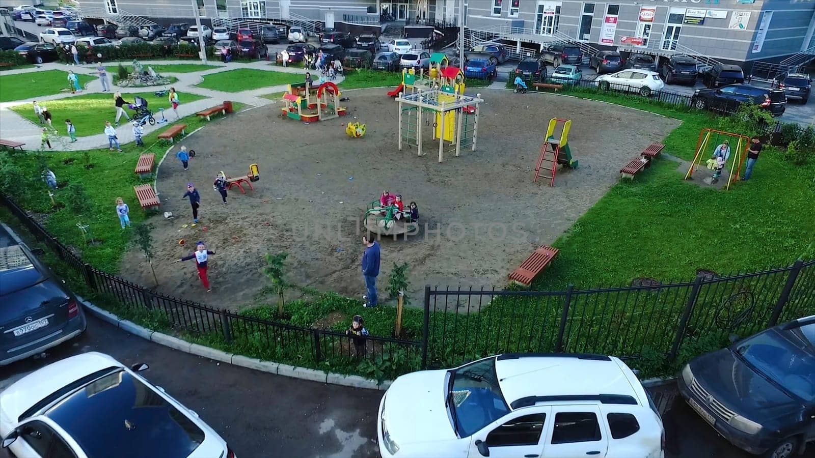 Top view of pretty little children is running on green grass, smiling and looking at camera. Clip. Children in the Park look at top.