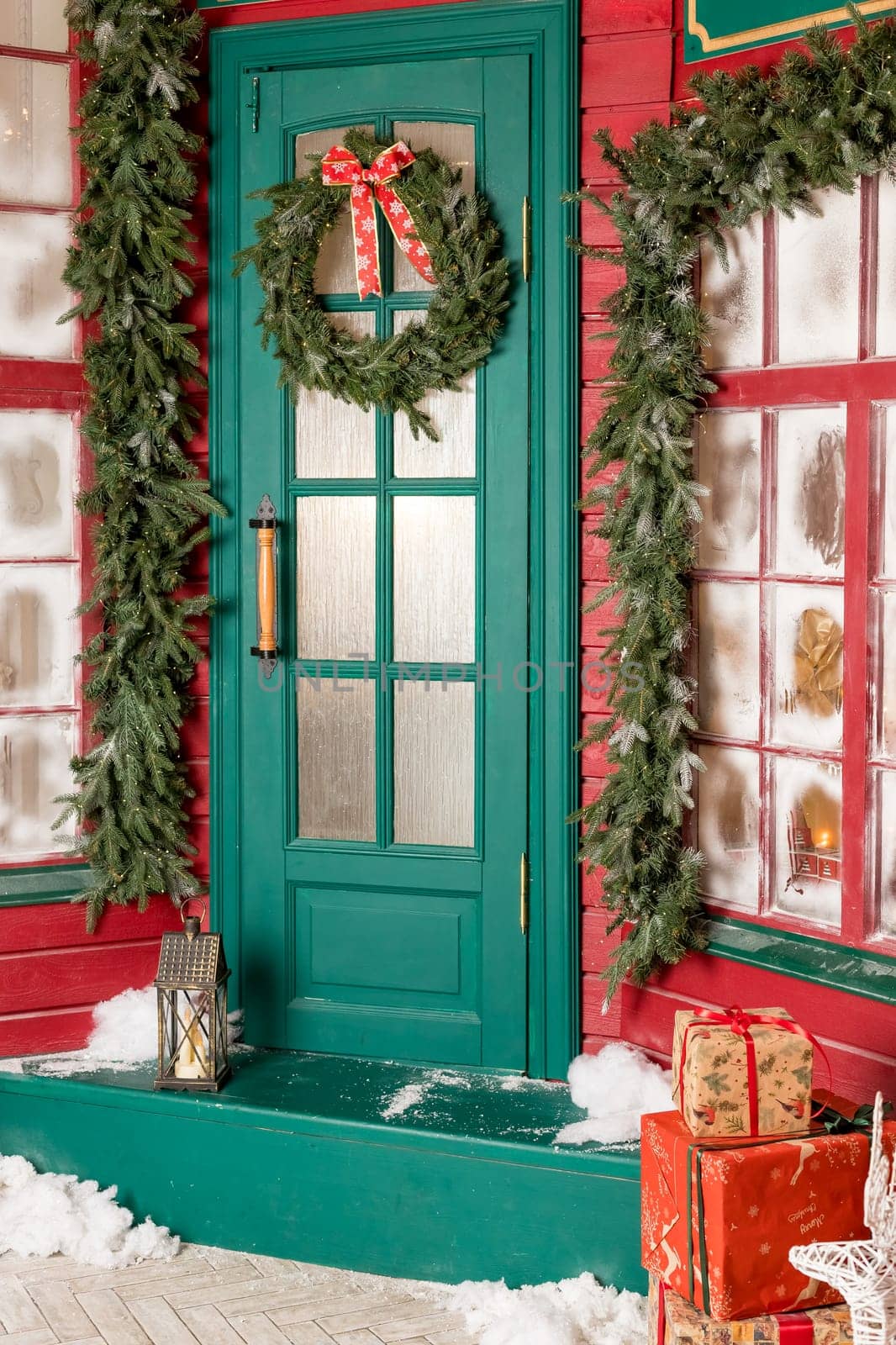 Wreath decoration at door for Christmas holiday.Traditional christmas wreath on old wooden green door in european city street. Stylish christmas street decor, Winter holidays by YuliaYaspe1979