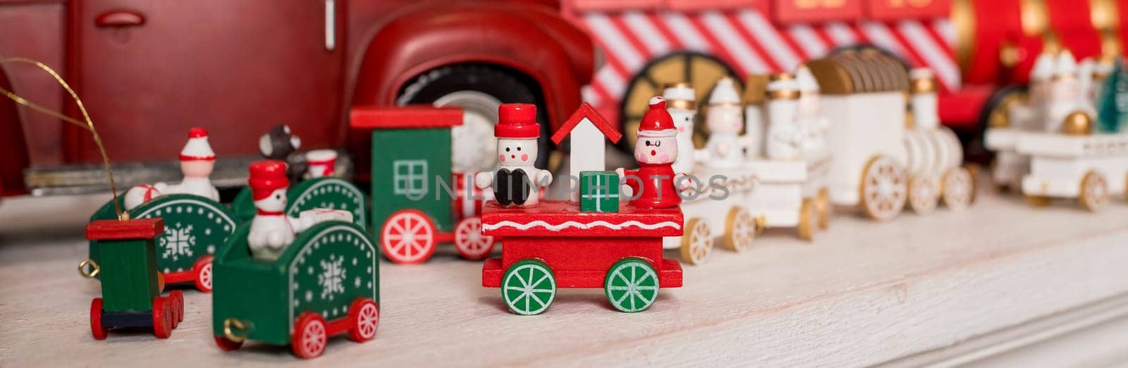 Wooden toy train. Christmas trip on a white isolated background. Christmas card. Copy space.