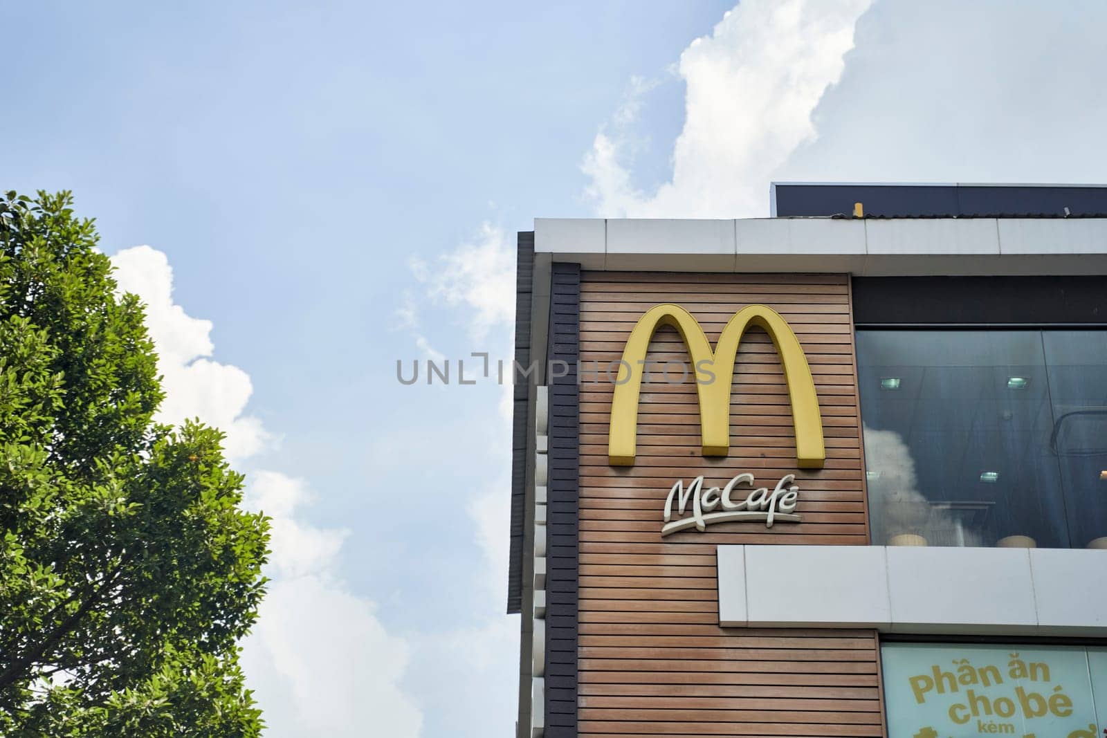 Ho Chi Minh City, Vietnam - 2.07.2023: Close-up of McDonald's logo and maccafe on building by driver-s