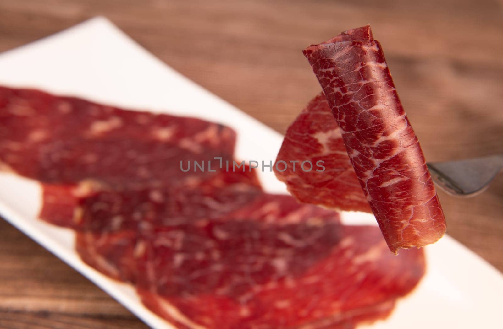 Dry-cured Spanish ham, Serrano ham, Bellota ham, Italian prosciutto crudo or Parma ham, wagyu slice. High quality photo