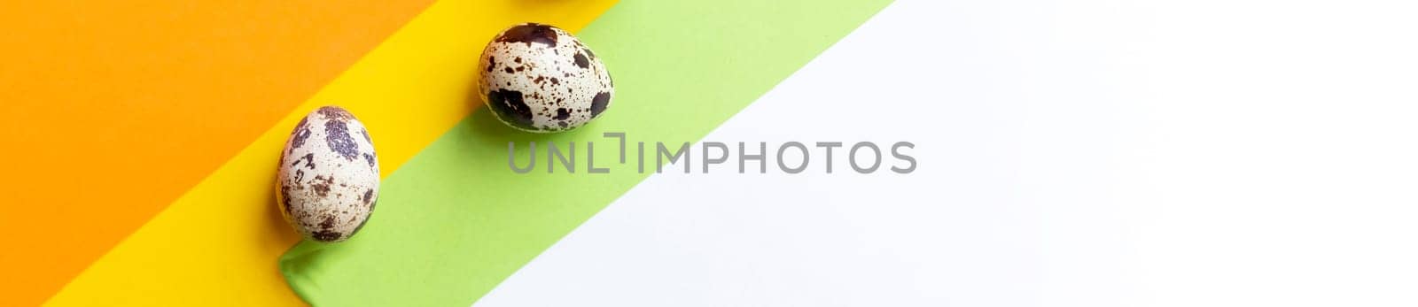 Creative quail egg layout on brown background. Quail eggs pattern. Happy easter concept.