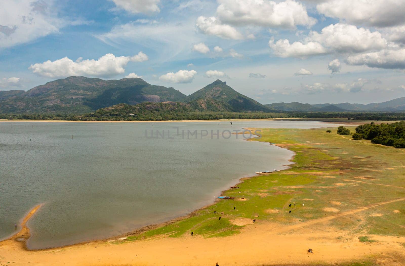 Tropical landscape: A lake in the middle of a forest against the background of mountains. Kandalama Reservoir in Sri Lanka.