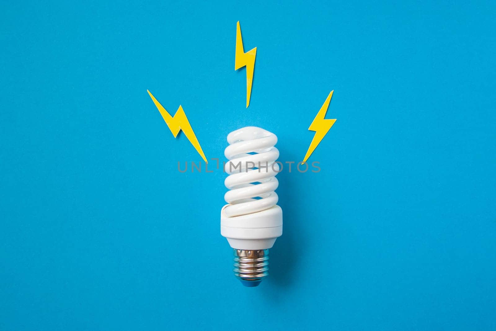 Light bulb with energy lightings on blue background by Quils