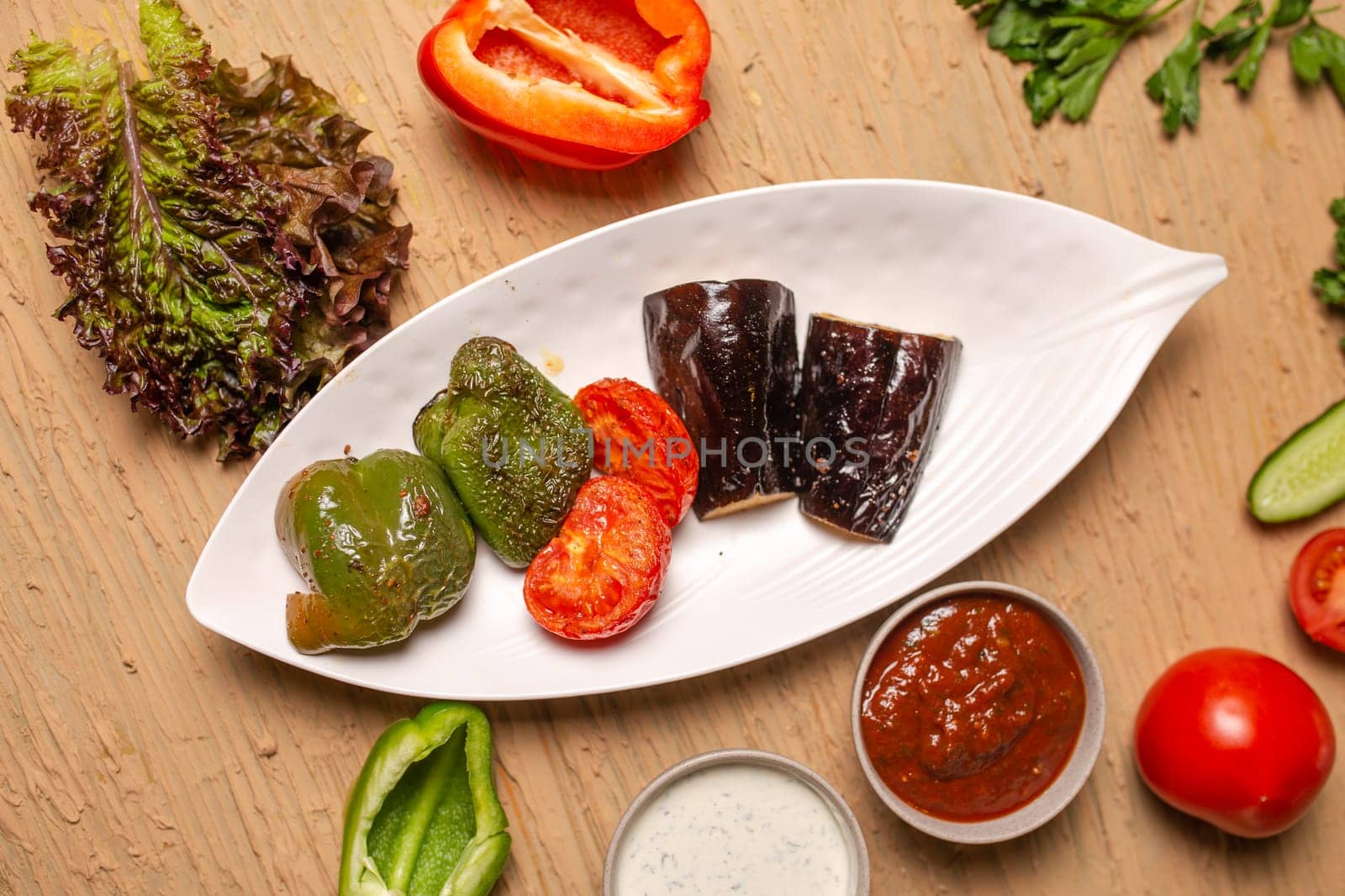 top view grilled vegetables cooked on the grill on a white plate.