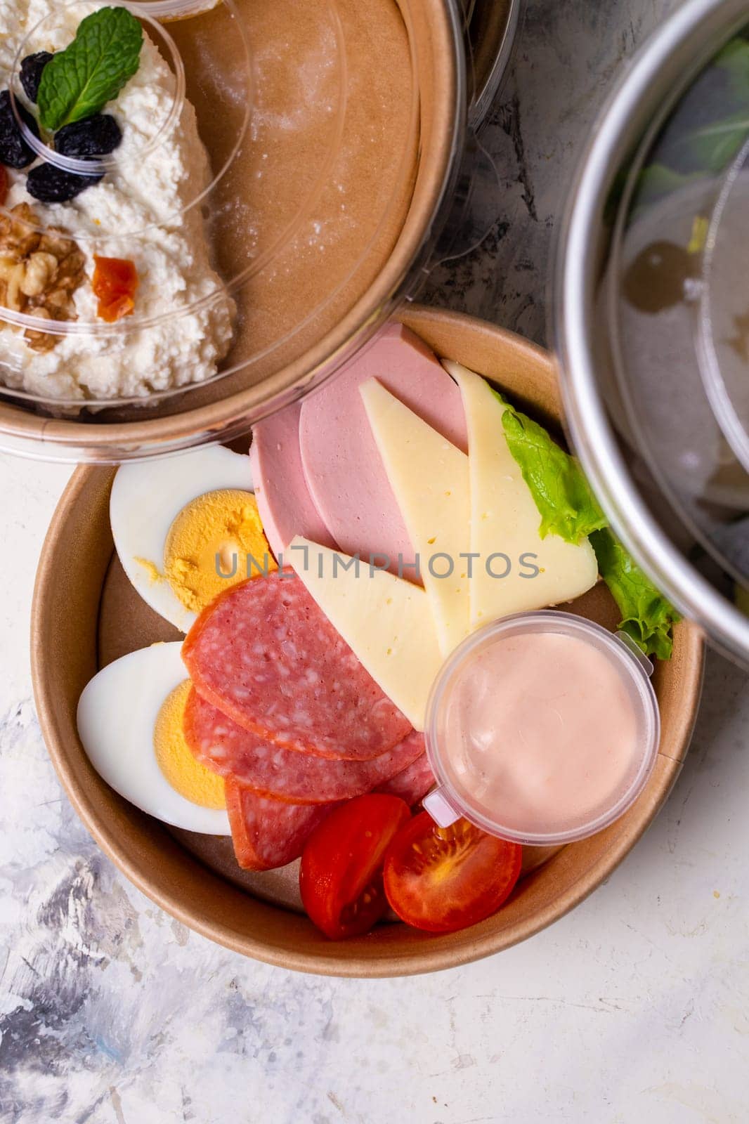 top view of a craft plate with breakfast close-up. Sausage, tomato, egg and cheese. by Pukhovskiy