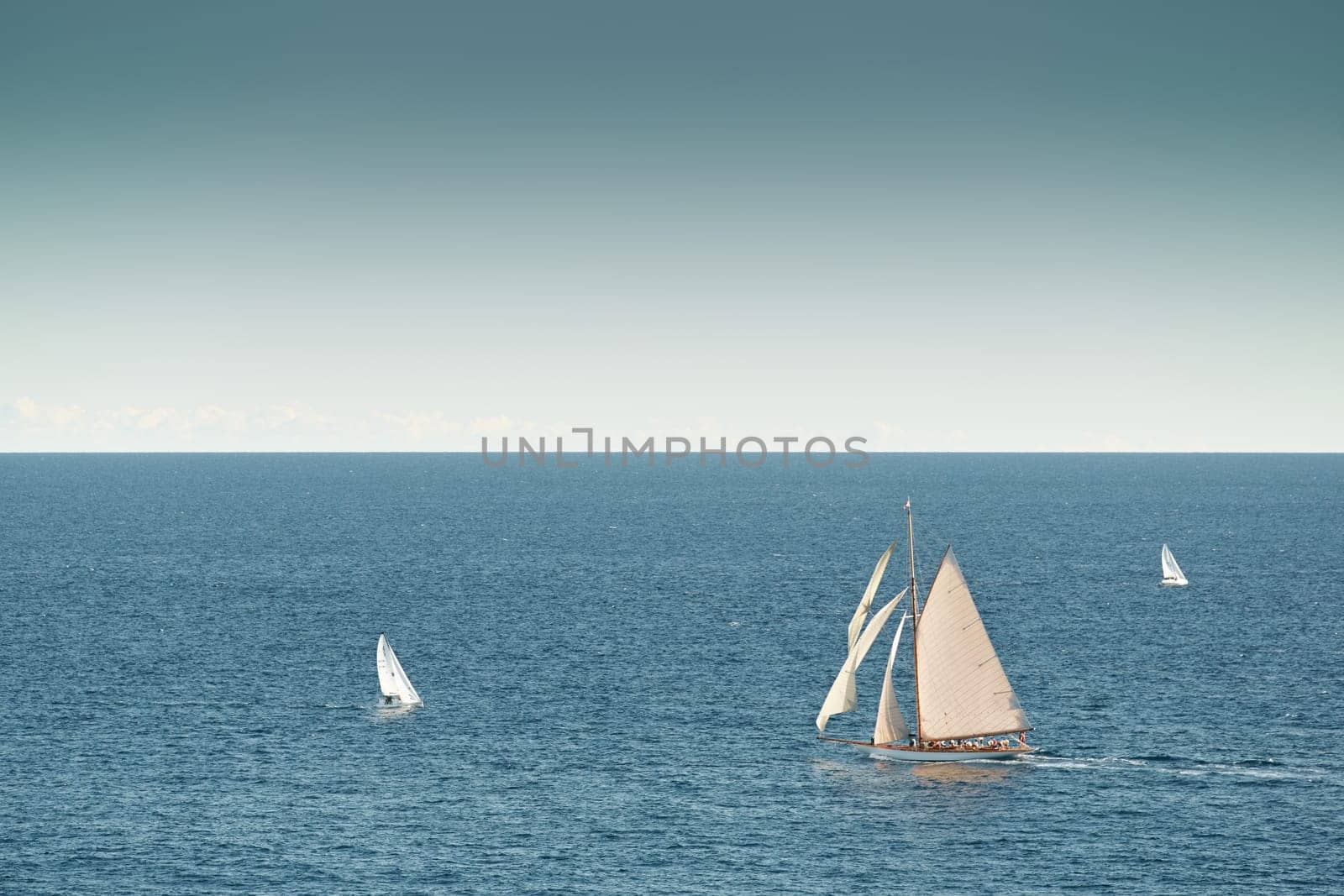 Monaco, lonely vintage sail yacht in sea at sunset, huge sail boat, wealth life of billionaires by vladimirdrozdin