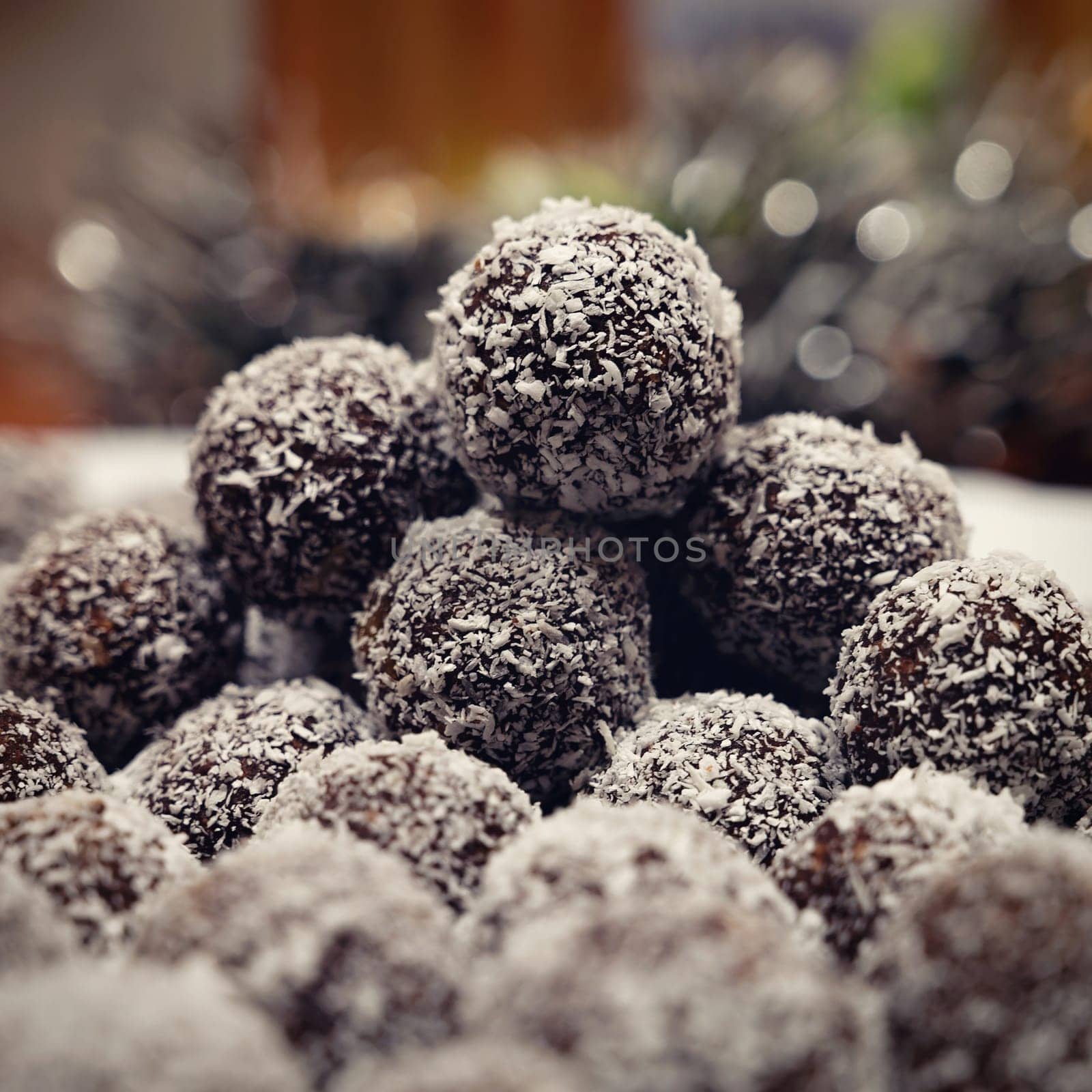 Rum balls in coconut. Traditional unbaked Czech sweets for Christmas and winter. Raw sweet food with cocoa and coconut. by Montypeter