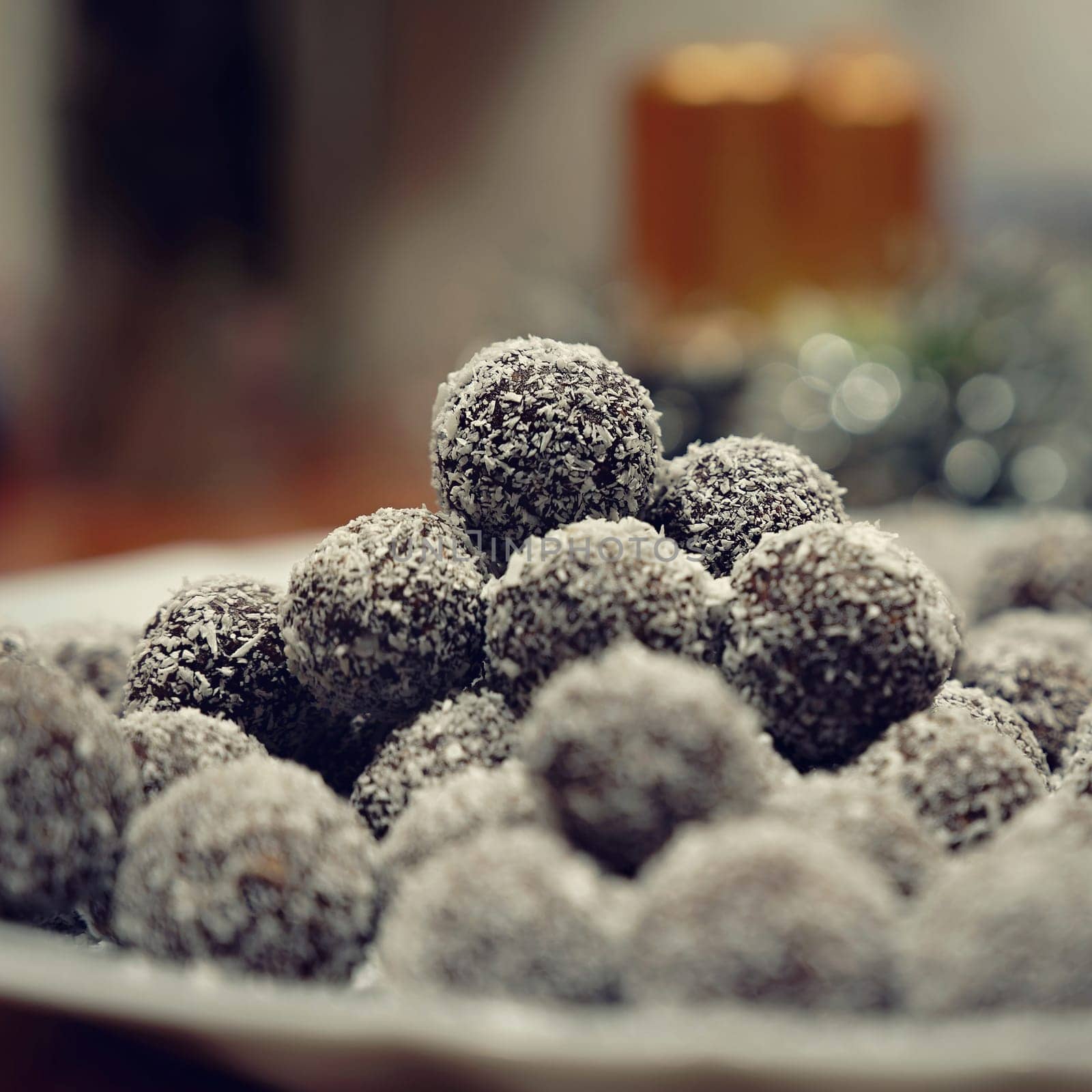 Rum balls in coconut. Traditional unbaked Czech sweets for Christmas and winter. Raw sweet food with cocoa and coconut.