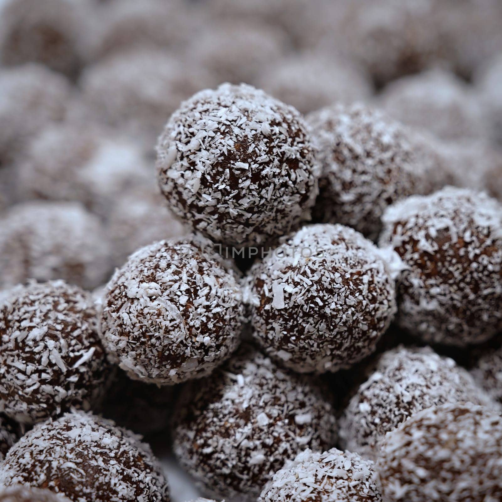 Rum balls in coconut. Traditional unbaked Czech sweets for Christmas and winter. Raw sweet food with cocoa and coconut.