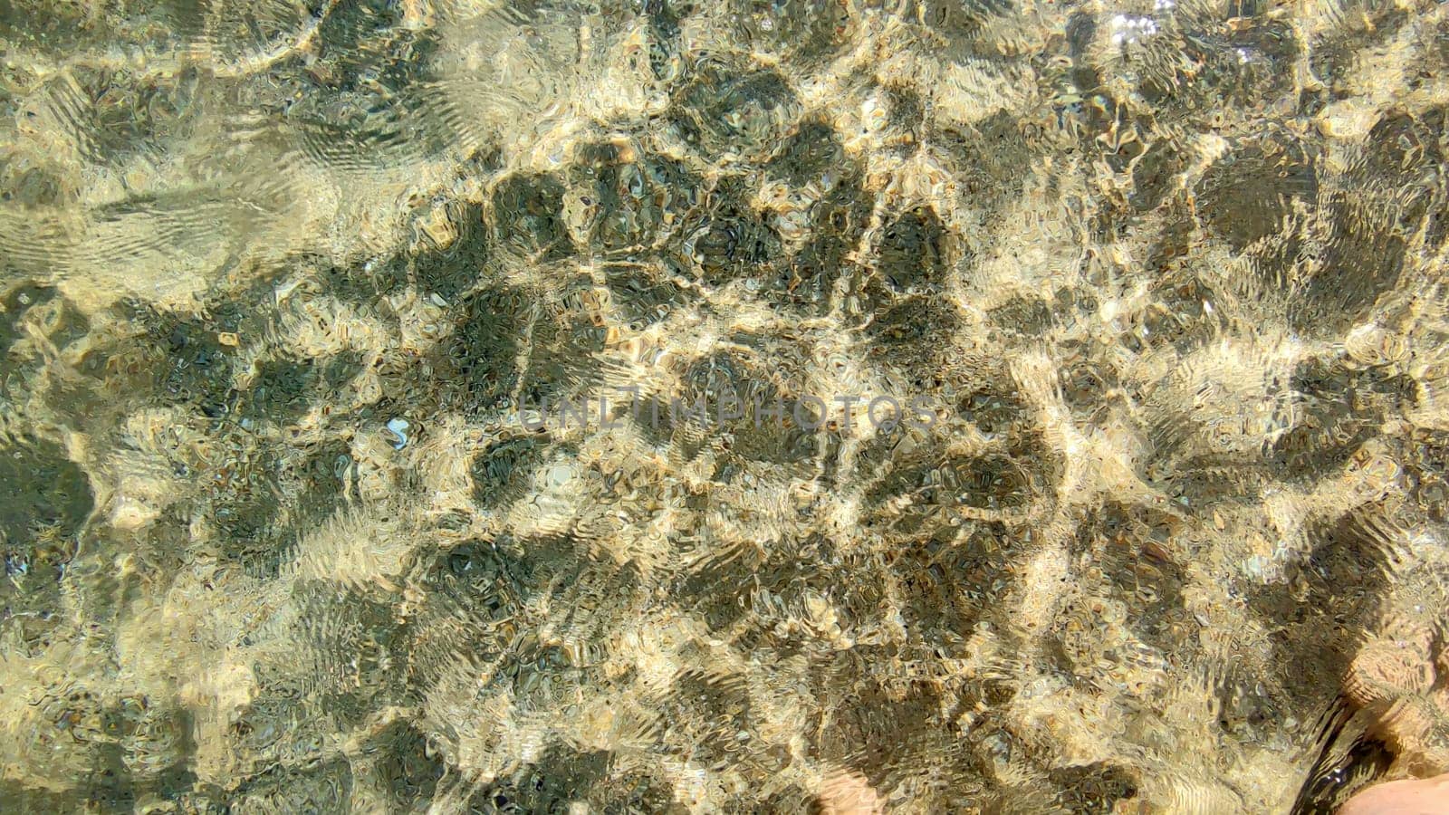 clean transparent sea water in shallow water in which sunlight is reflected by Annado