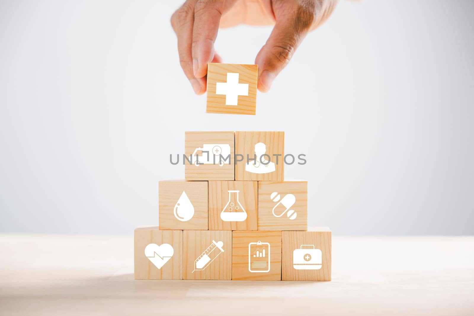 Hand hold wooden block with icon healthcare medical by Sorapop