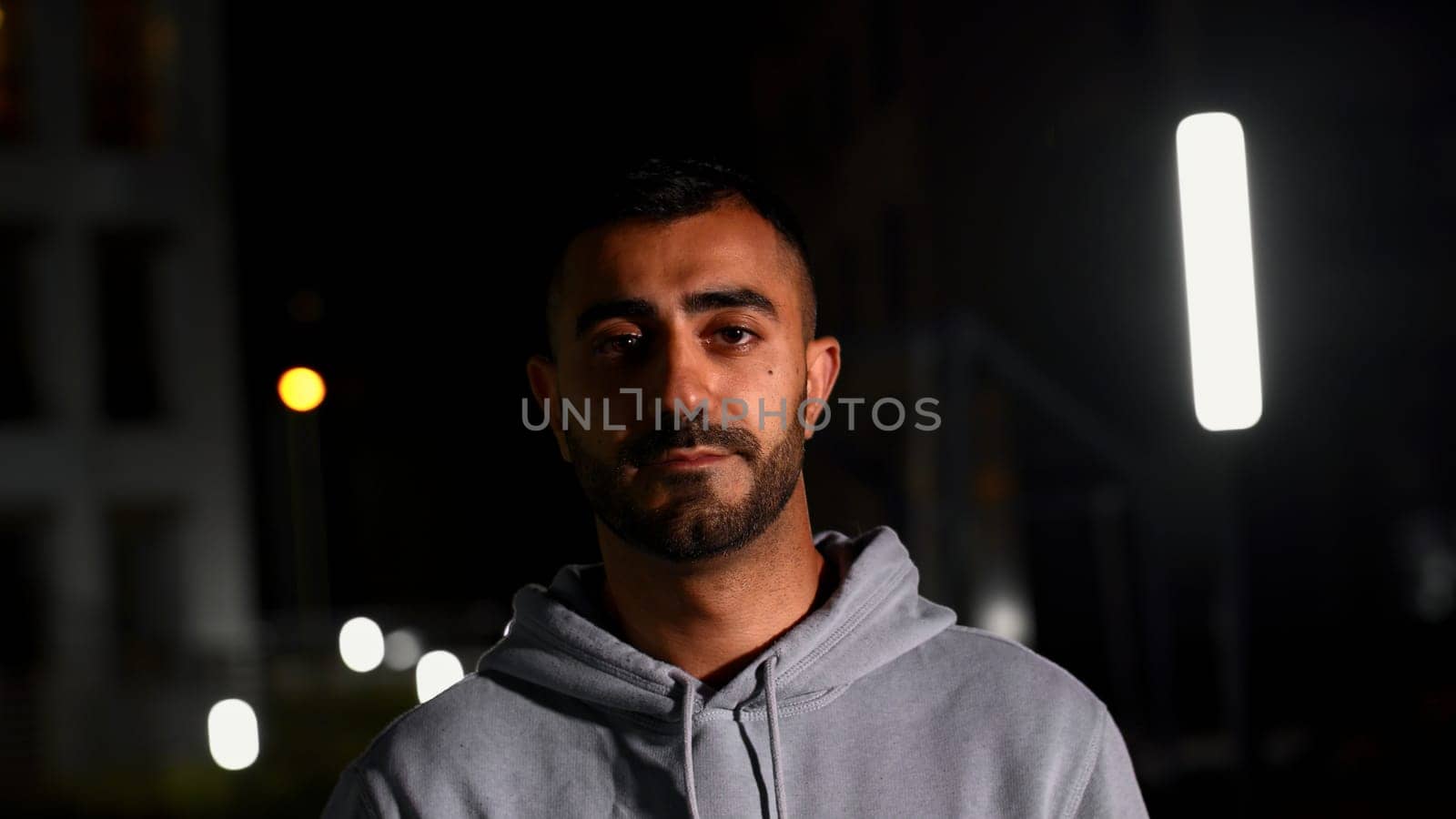 Night portrait with a gloomy man. Media. Late evening with a handsome well-groomed man who frowns. High quality 4k footage
