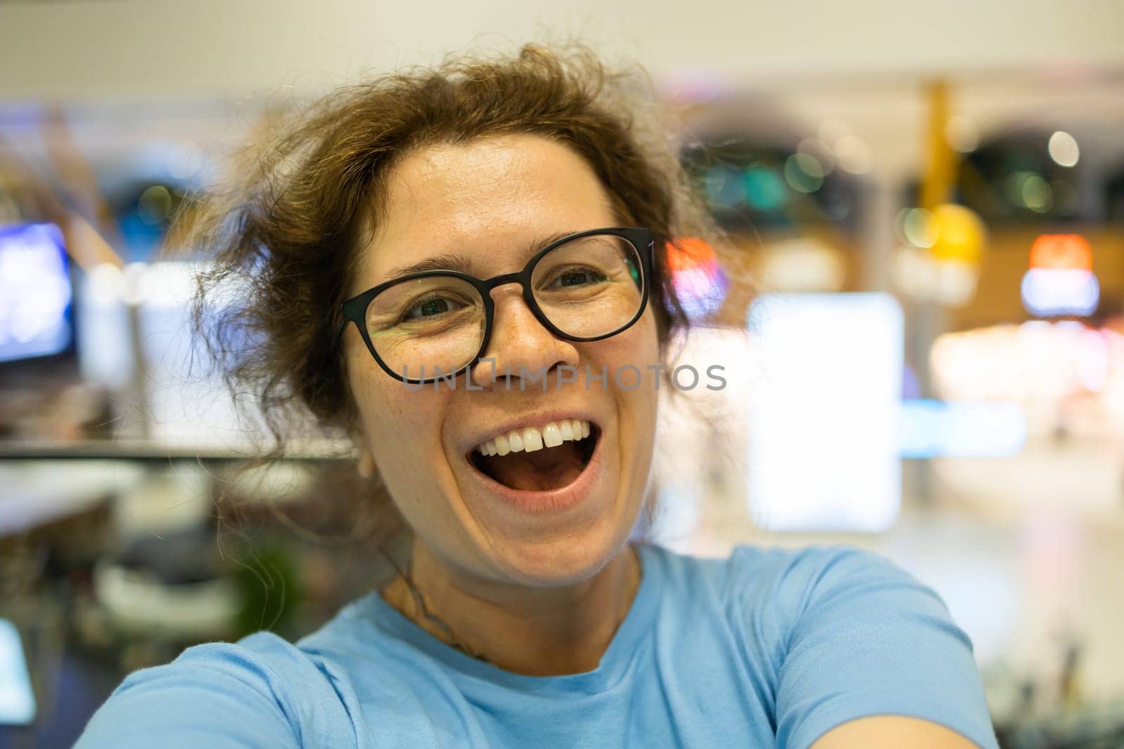 Video call portrait of excited cheerful smiling woman in spectacles taking selfie photo. Selfie and blogger