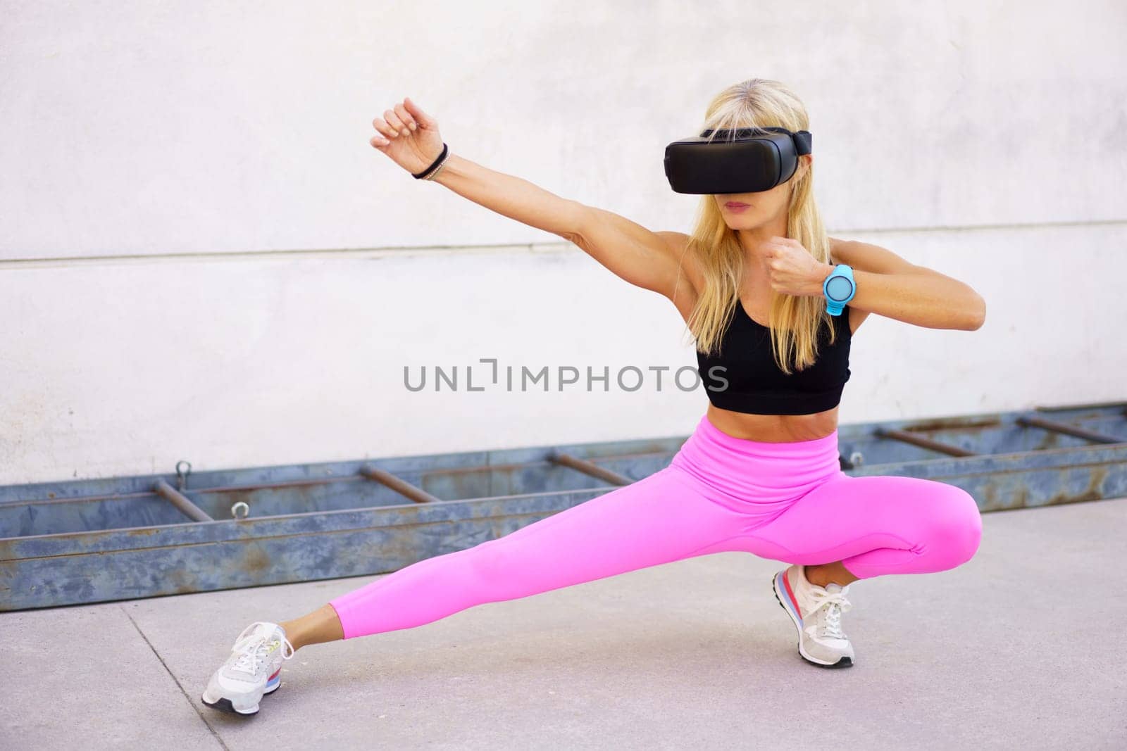 Strong sportswoman practicing martial arts in VR headset by javiindy