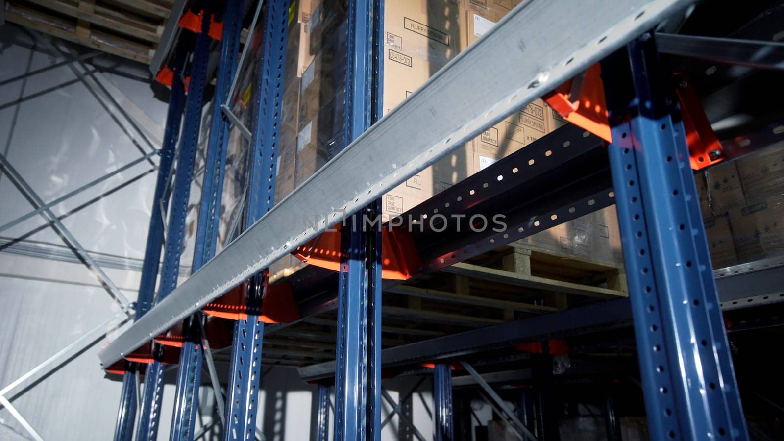 Moscow - Russia, 04.20.2022: Warehouse materials and metal shelves with goods inside cardbox boxes. Creative. The camera moves among the shelves with different boxes. by Mediawhalestock