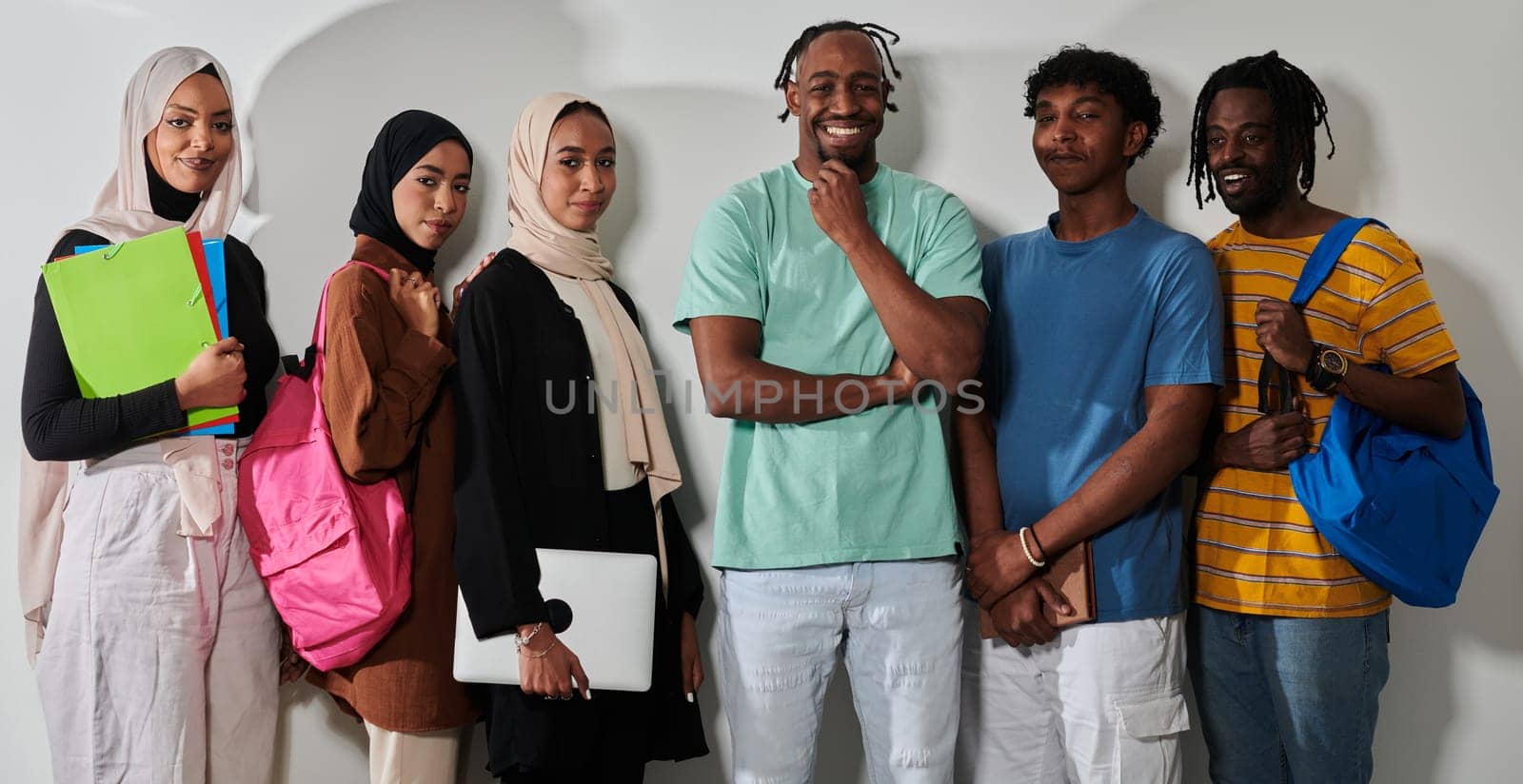 In a vibrant display of educational diversity, a group of students strikes a pose against a clean white background, holding backpacks, laptops, and tablets, symbolizing a blend of modern technology, unity, and cultural inclusivity in their academic journey by dotshock